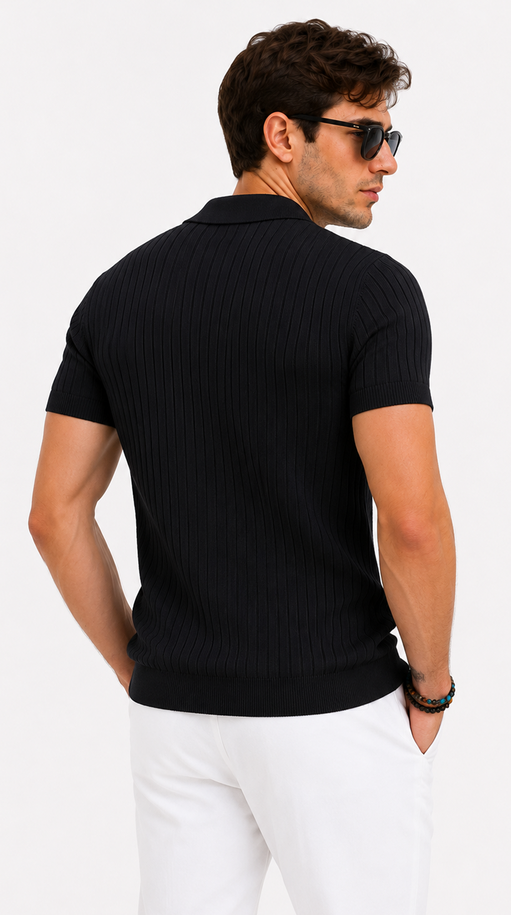 A man wearing a black short-sleeve ribbed knit polo shirt, shown from the back, paired with white trousers against a plain white studio background, from Meleche Fashion USA or Meléche (short as (Mé))