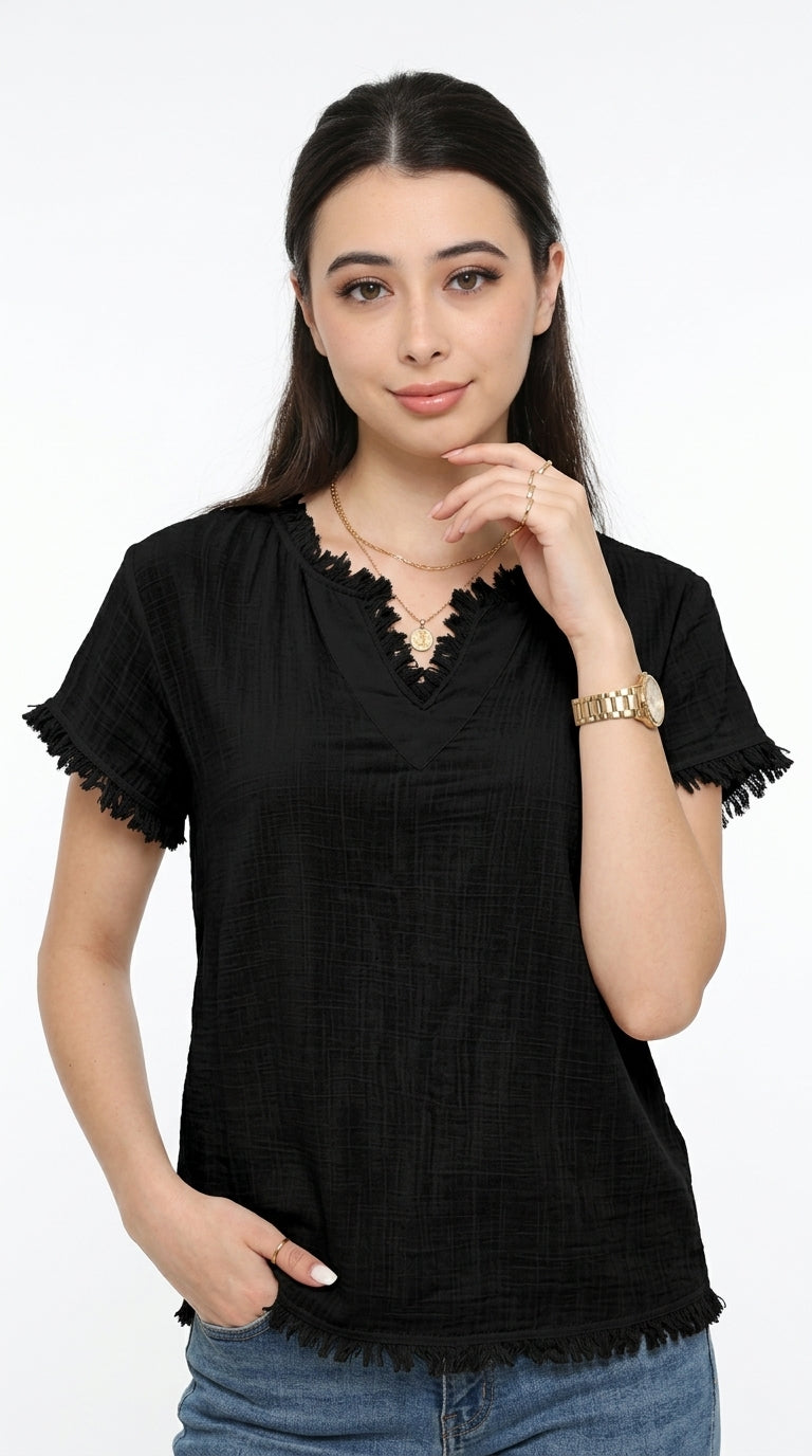 A woman modeling a black short-sleeve top with scalloped and frayed trim details on the neckline and sleeves, paired with blue jeans against a plain white background, from Meleche Fashion USA or Meléche (short as (Mé))