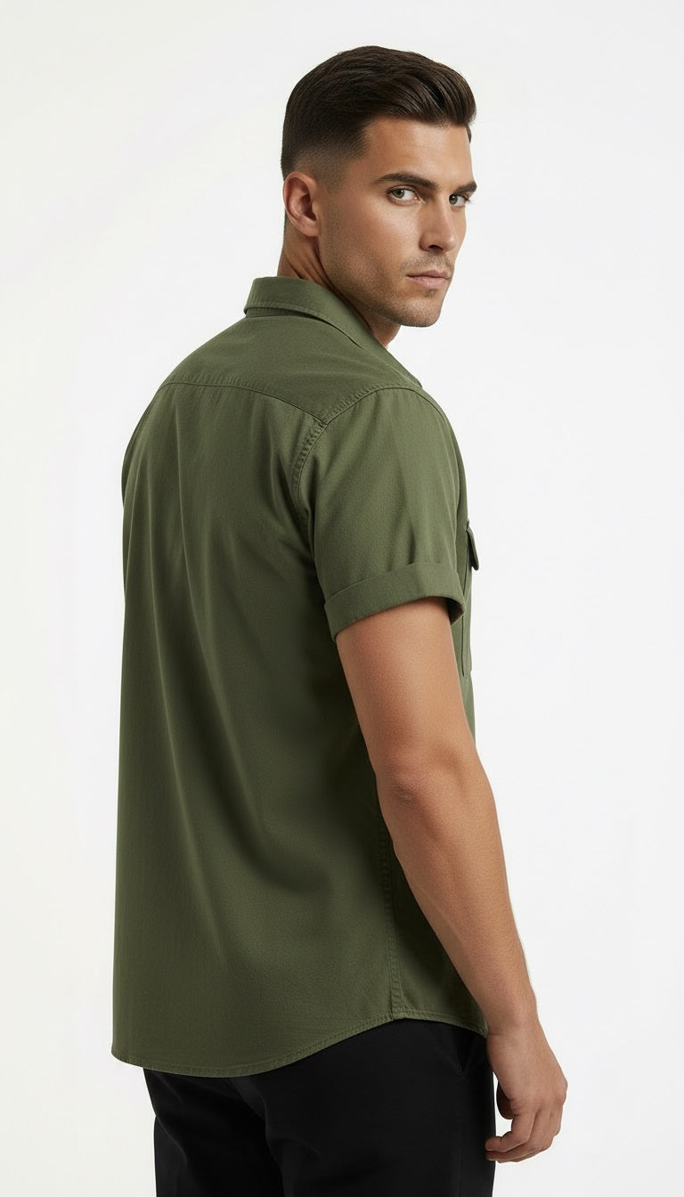 Two folded shirts, one green and one black, on a wooden surface.