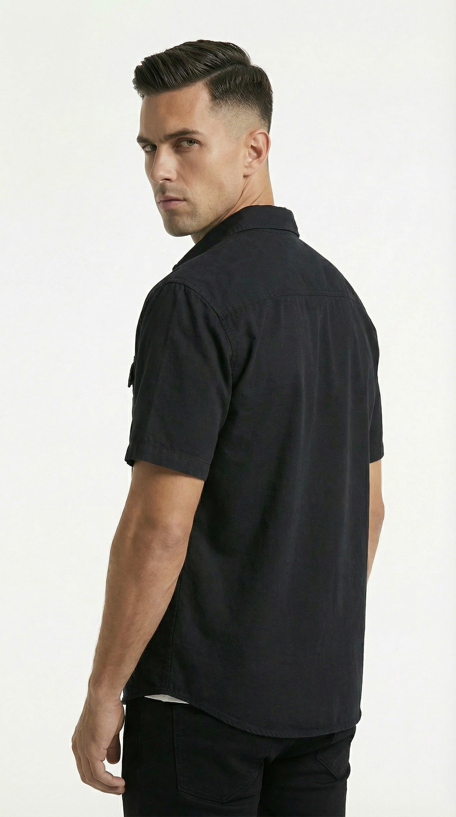 Folded black and green shirts on a wooden surface