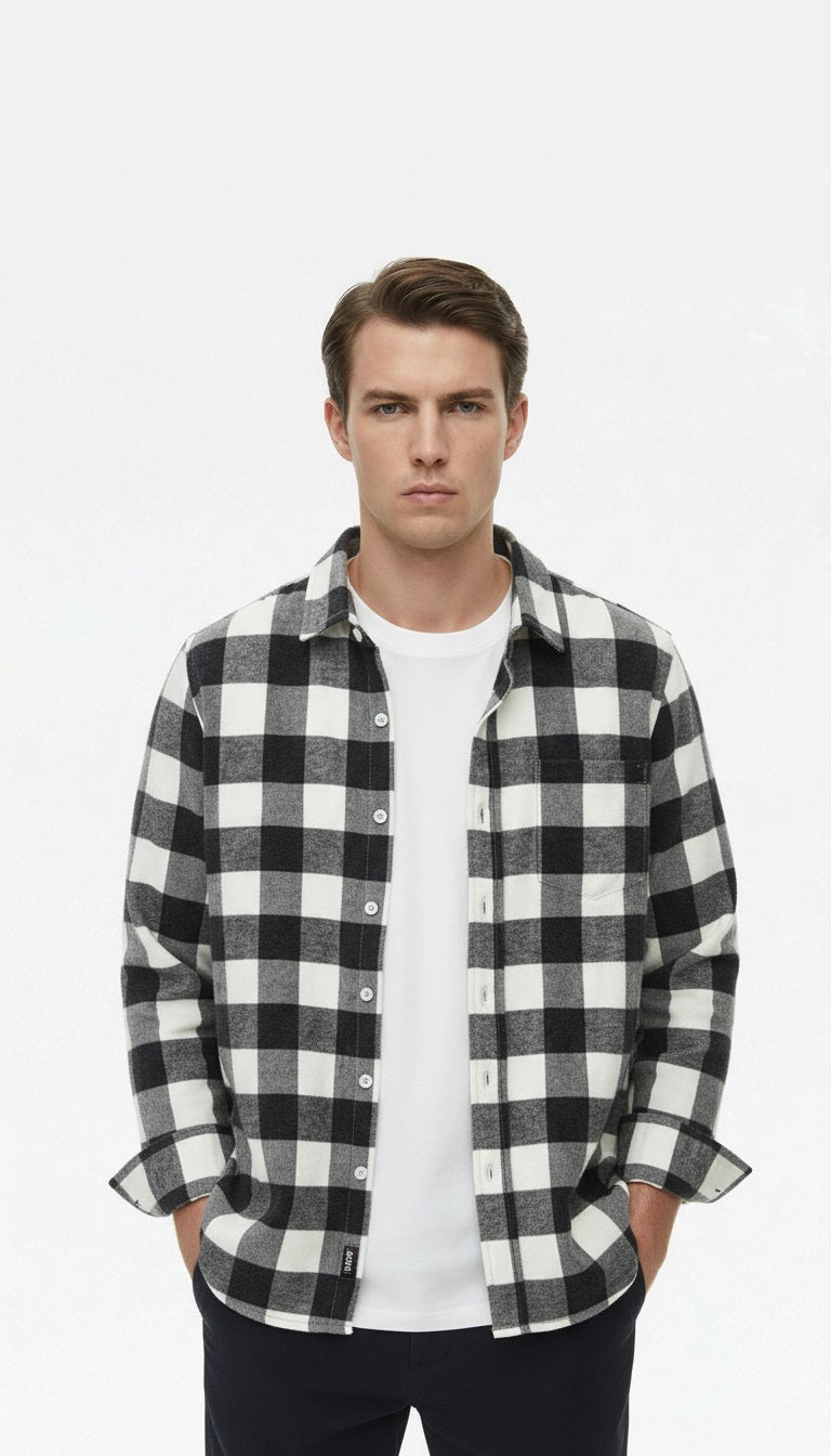 Black and white checkered shirt on a hanger against a gray background