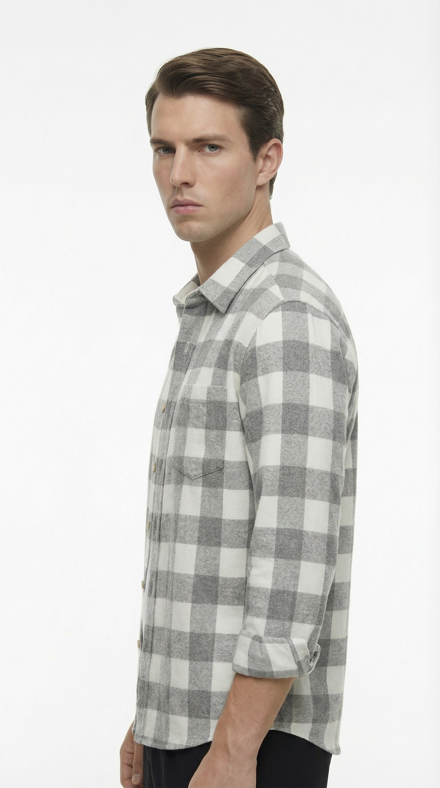 Man wearing a gray and white checkered shirt on a white background