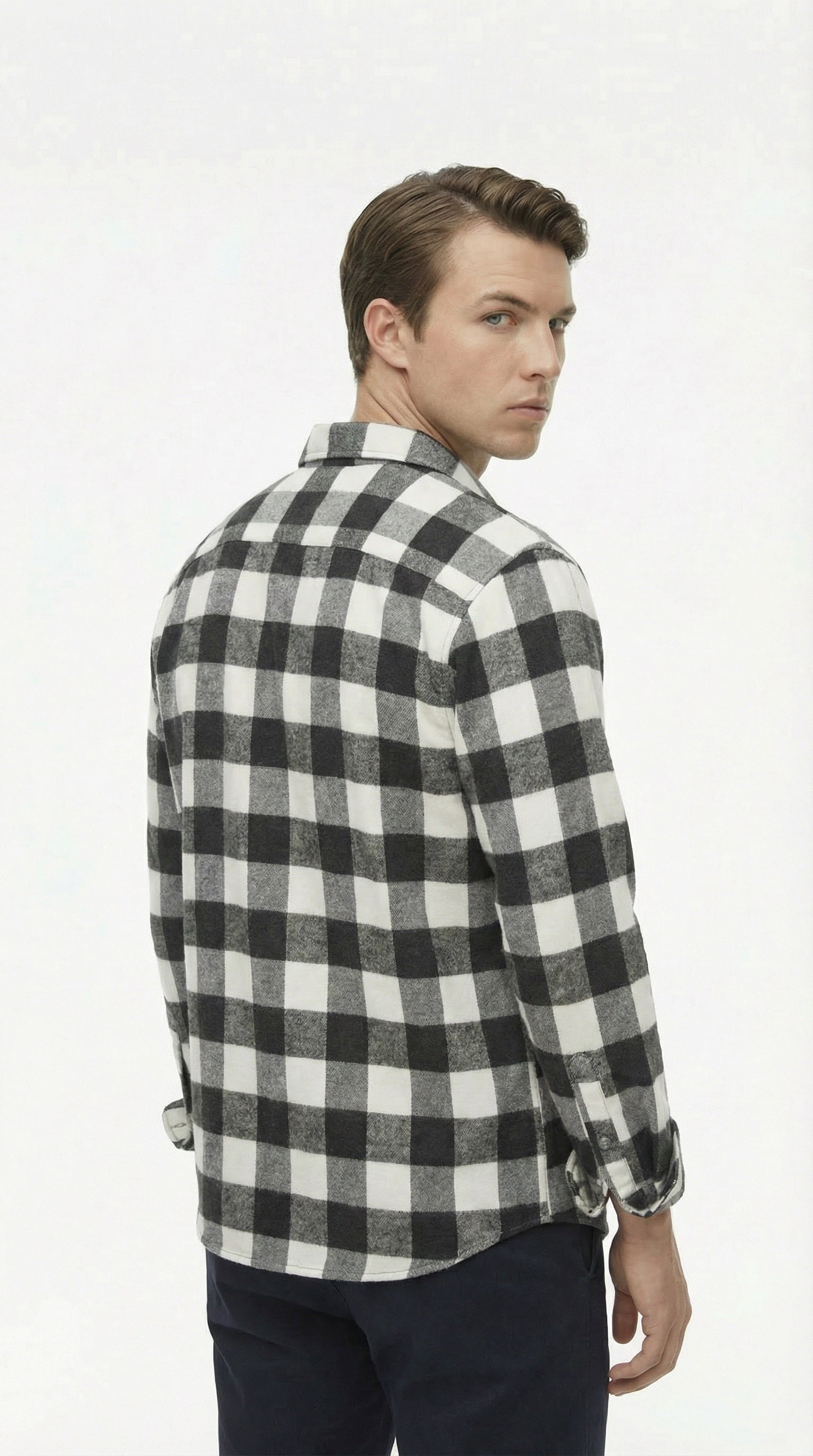Man wearing a black and white checkered shirt on a white background