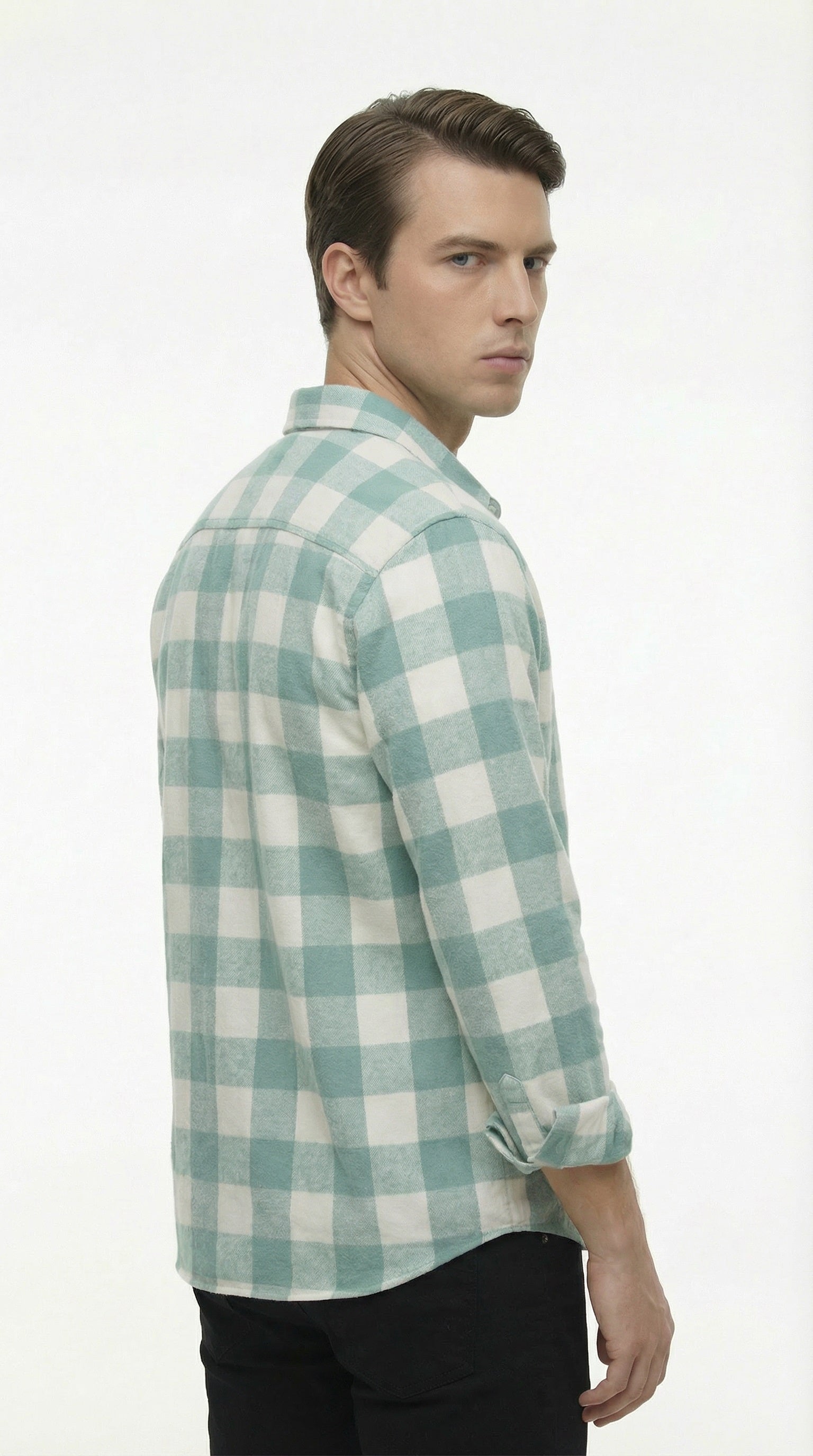 Green and white checkered shirt on a hanger against a gray background