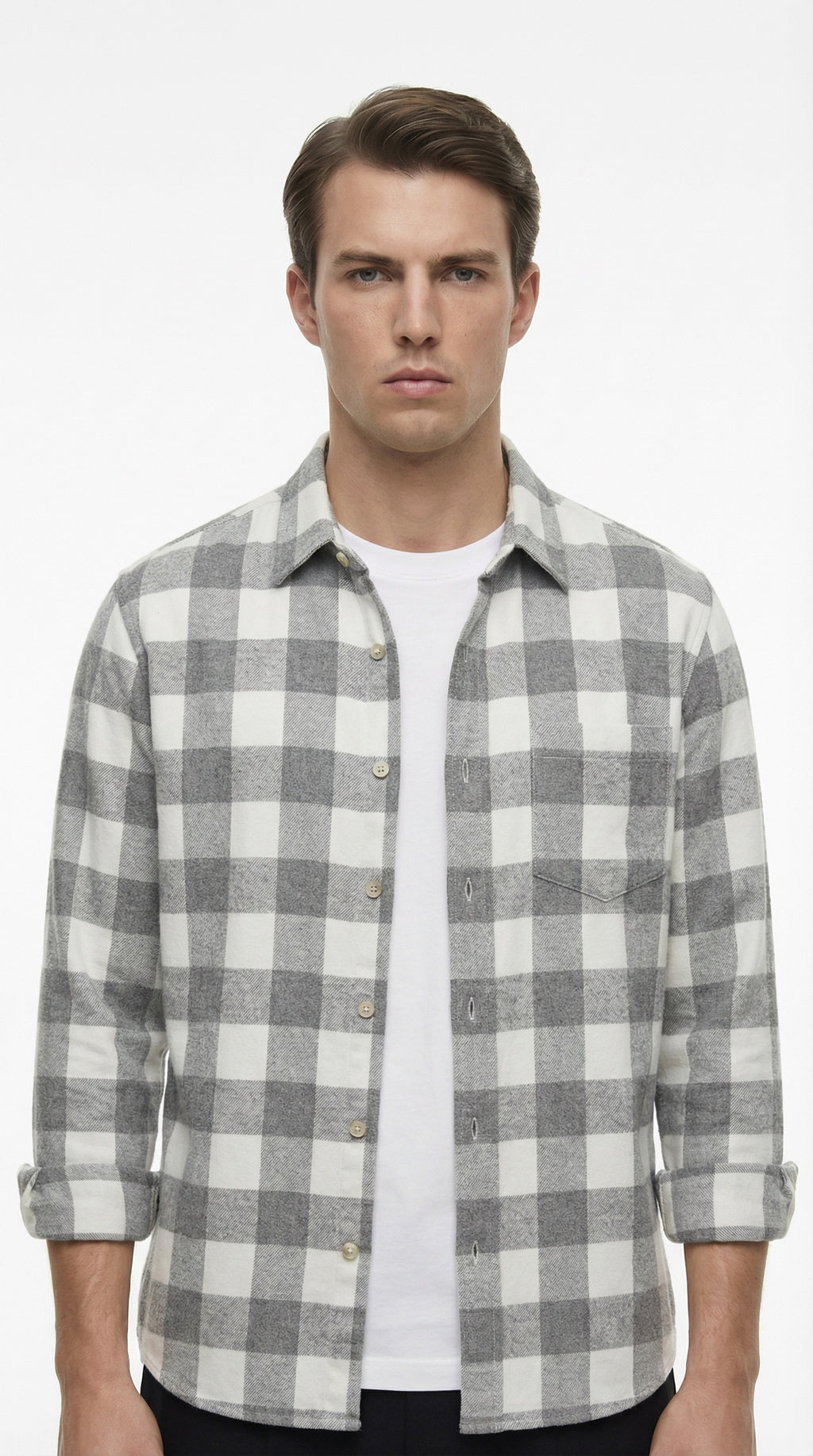 Gray and white plaid shirt on a hanger against a gray background