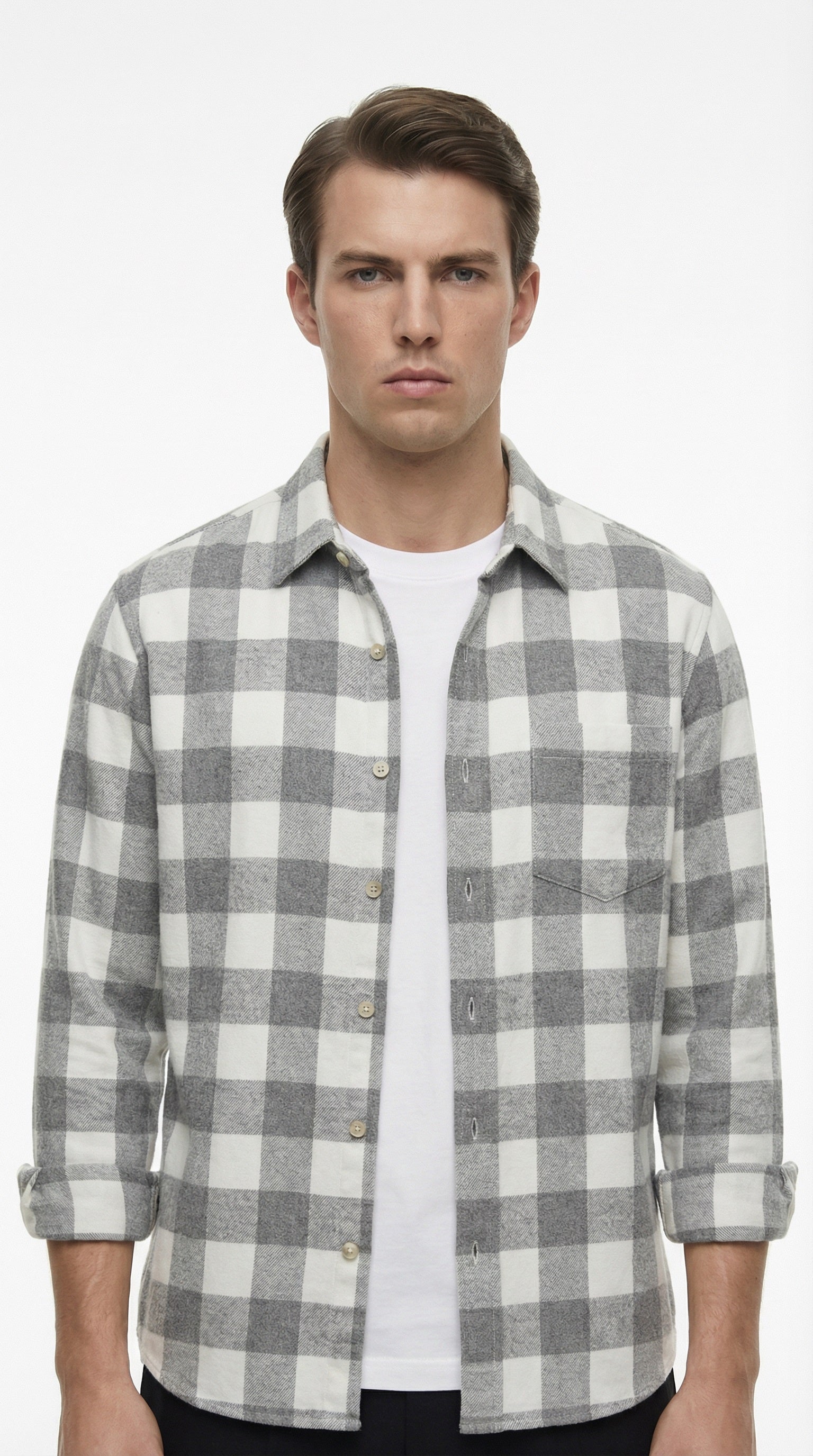 Gray and white plaid shirt on a hanger against a gray background