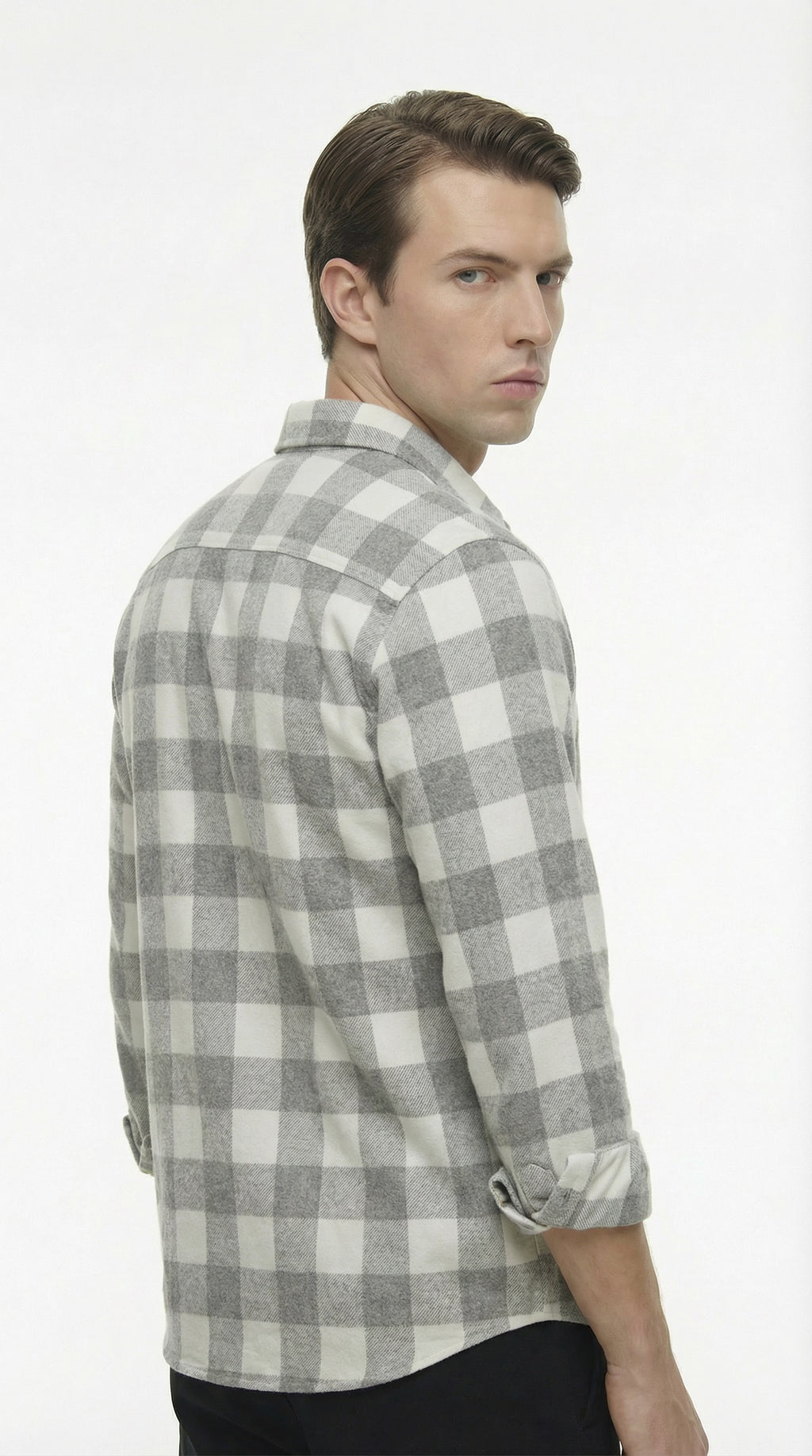 Man wearing a gray and white checkered shirt on a white background