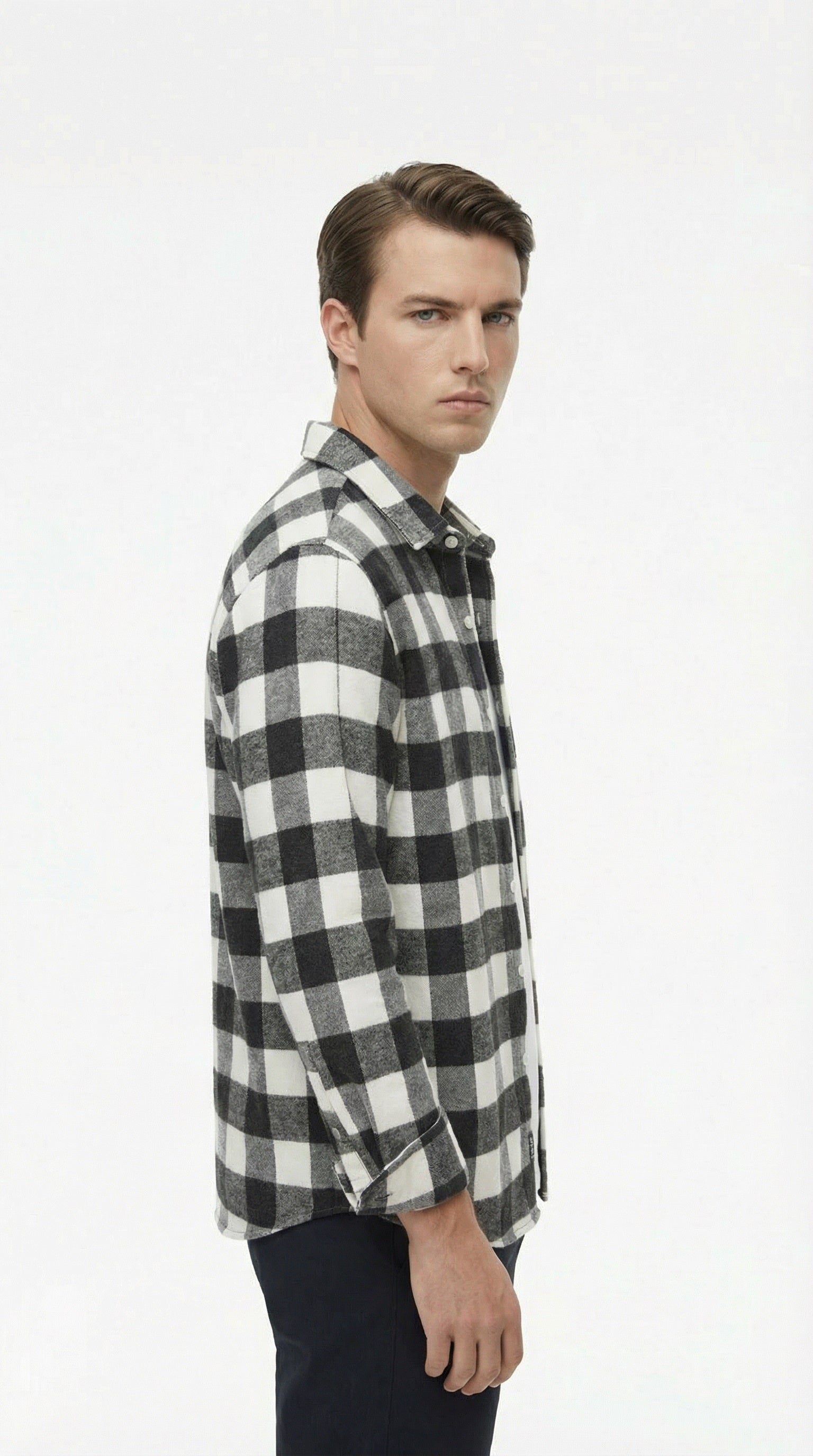 Black and white checkered shirt on a hanger against a gray background