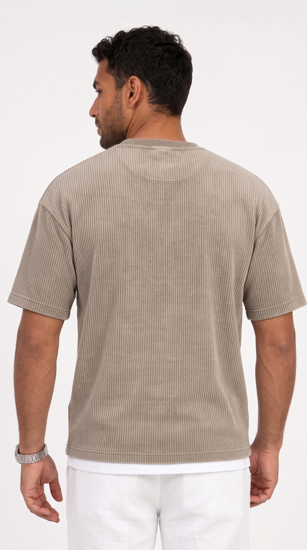 A man viewed from the back wearing a light taupe-beige short-sleeve ribbed t-shirt and white pants, set against a plain white studio background, from Meleche Fashion USA or Meléche (short as (Mé))