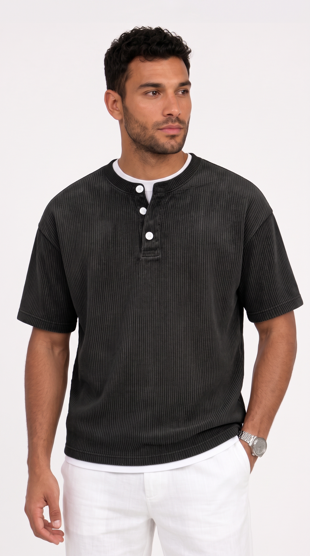 A man wearing a dark charcoal gray ribbed short-sleeve henley shirt with a white undershirt and white pants, standing against a plain white studio background, from Meleche Fashion USA or Meléche (short as (Mé))