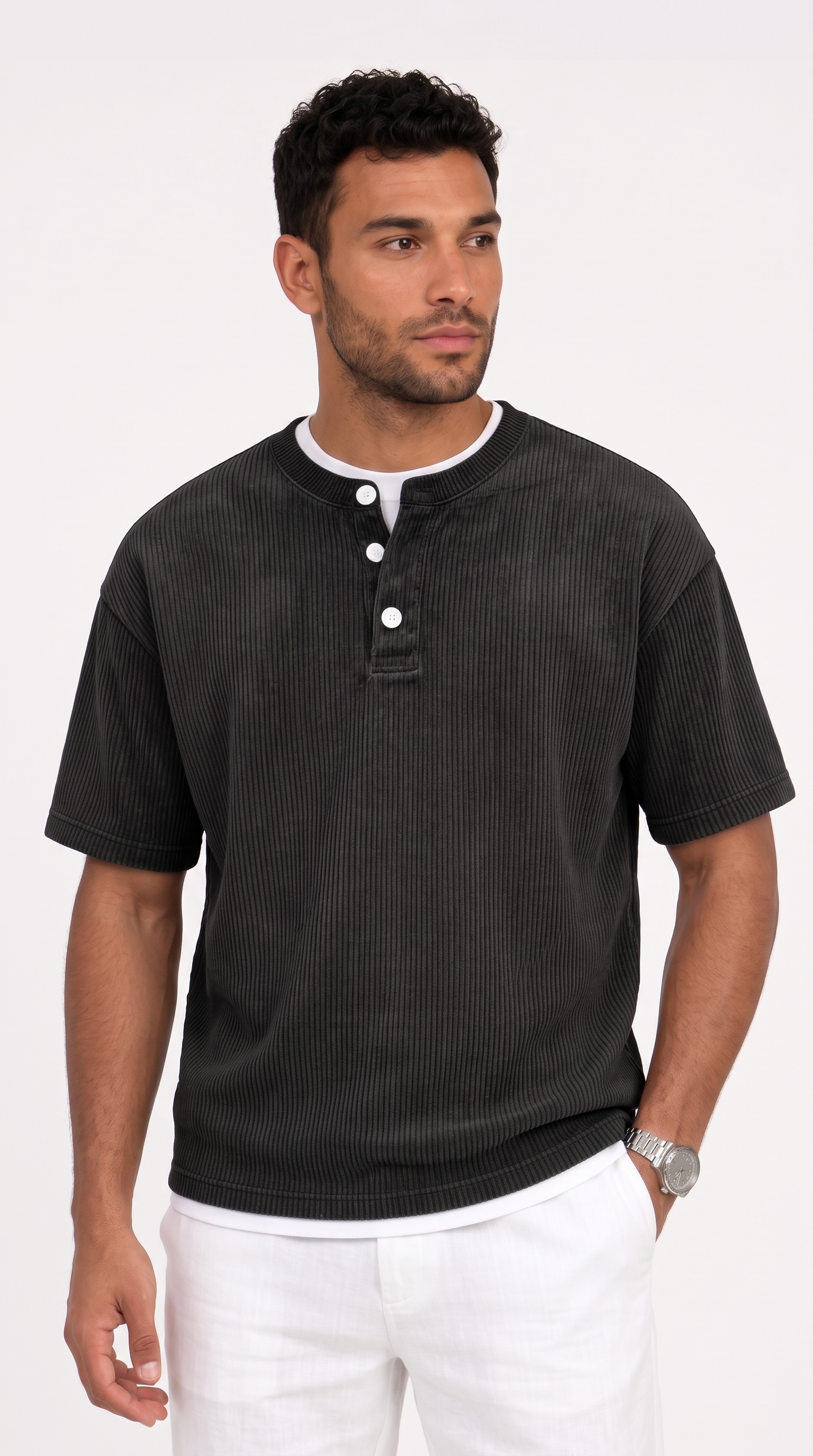 A man wearing a dark charcoal gray ribbed short-sleeve henley shirt with a white undershirt and white pants, standing against a plain white studio background, from Meleche Fashion USA or Meléche (short as (Mé))