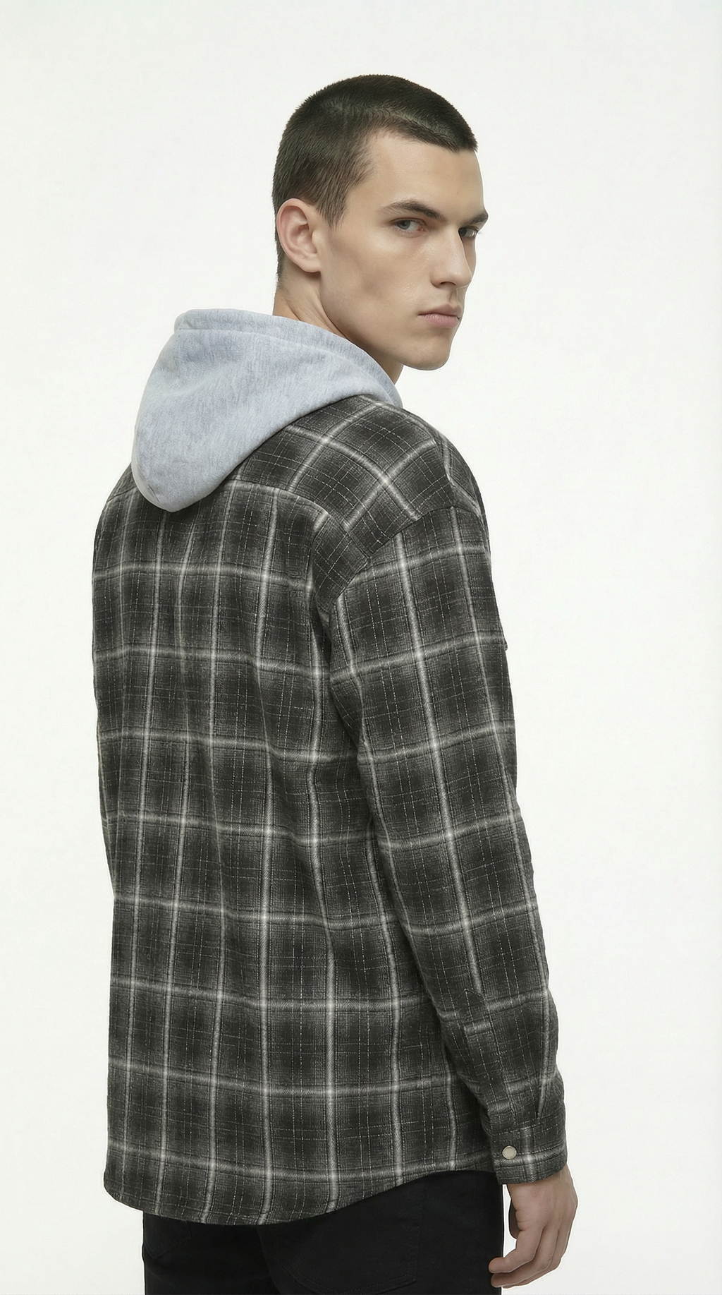 Man wearing a plaid shirt with a gray hood on a white background