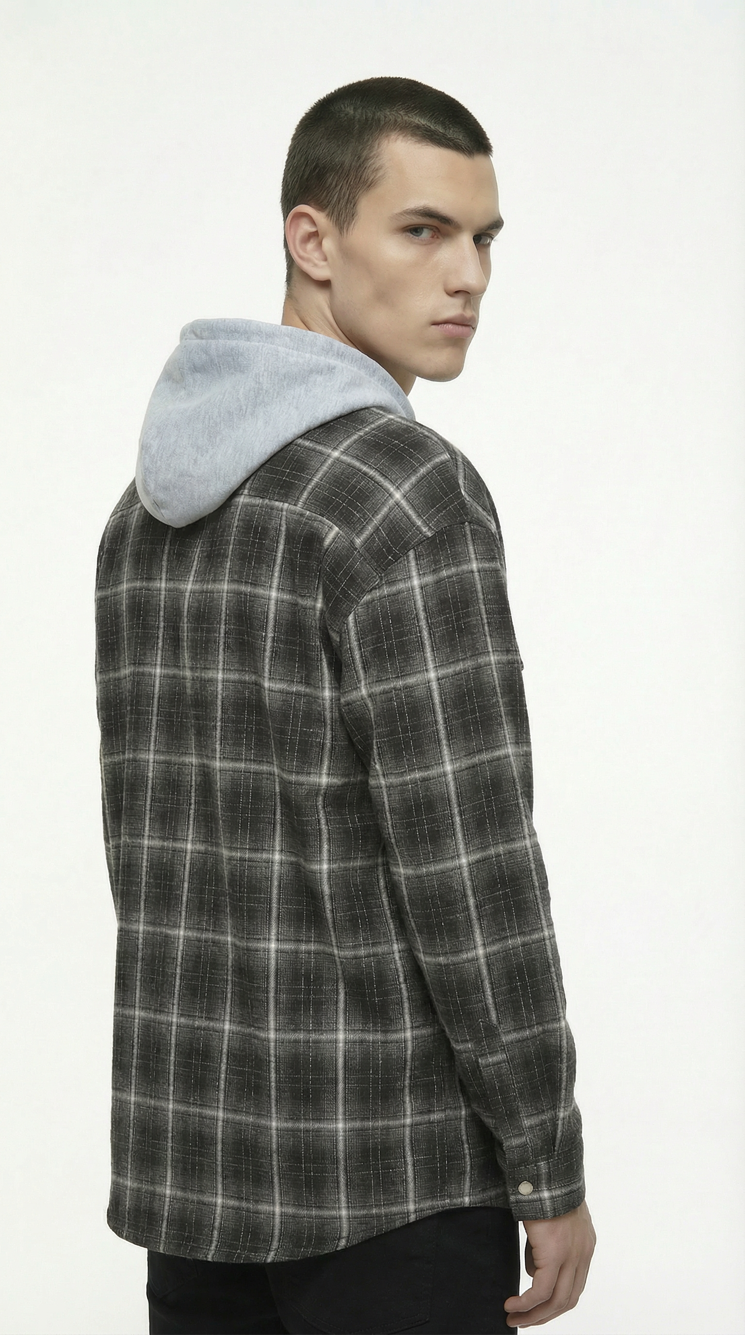 Man wearing a plaid shirt with a gray hood on a white background