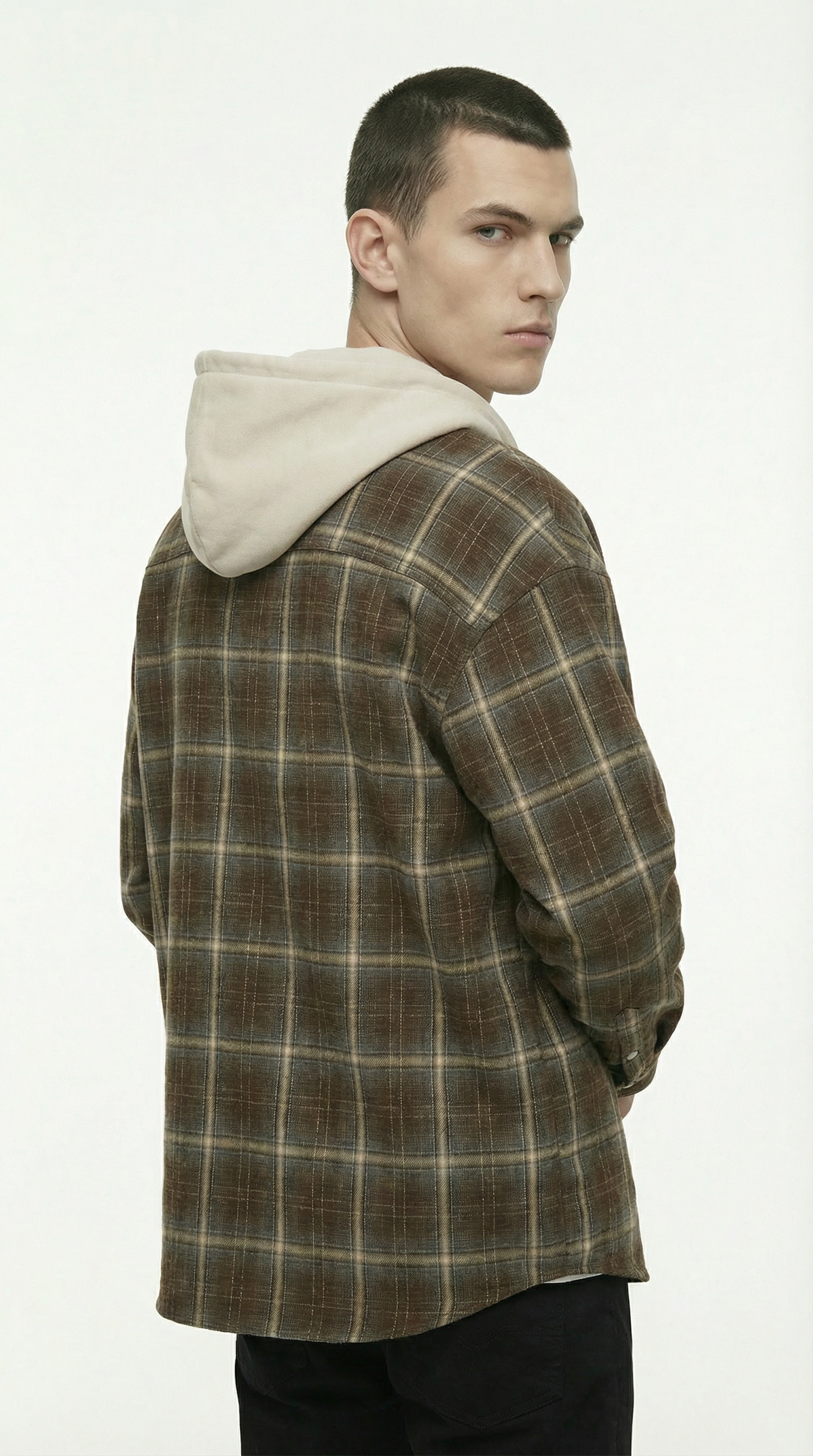 Man wearing a plaid jacket with a hood on a white background