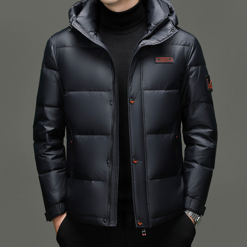 Black puffer jacket with a brand logo on a gray background