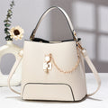 Xen - Beige handbag with a chain detail on a light background