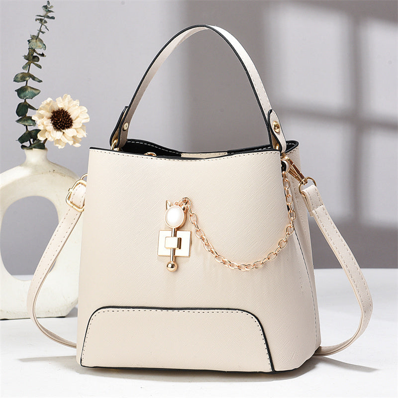 Xen - Beige handbag with a chain detail on a light background