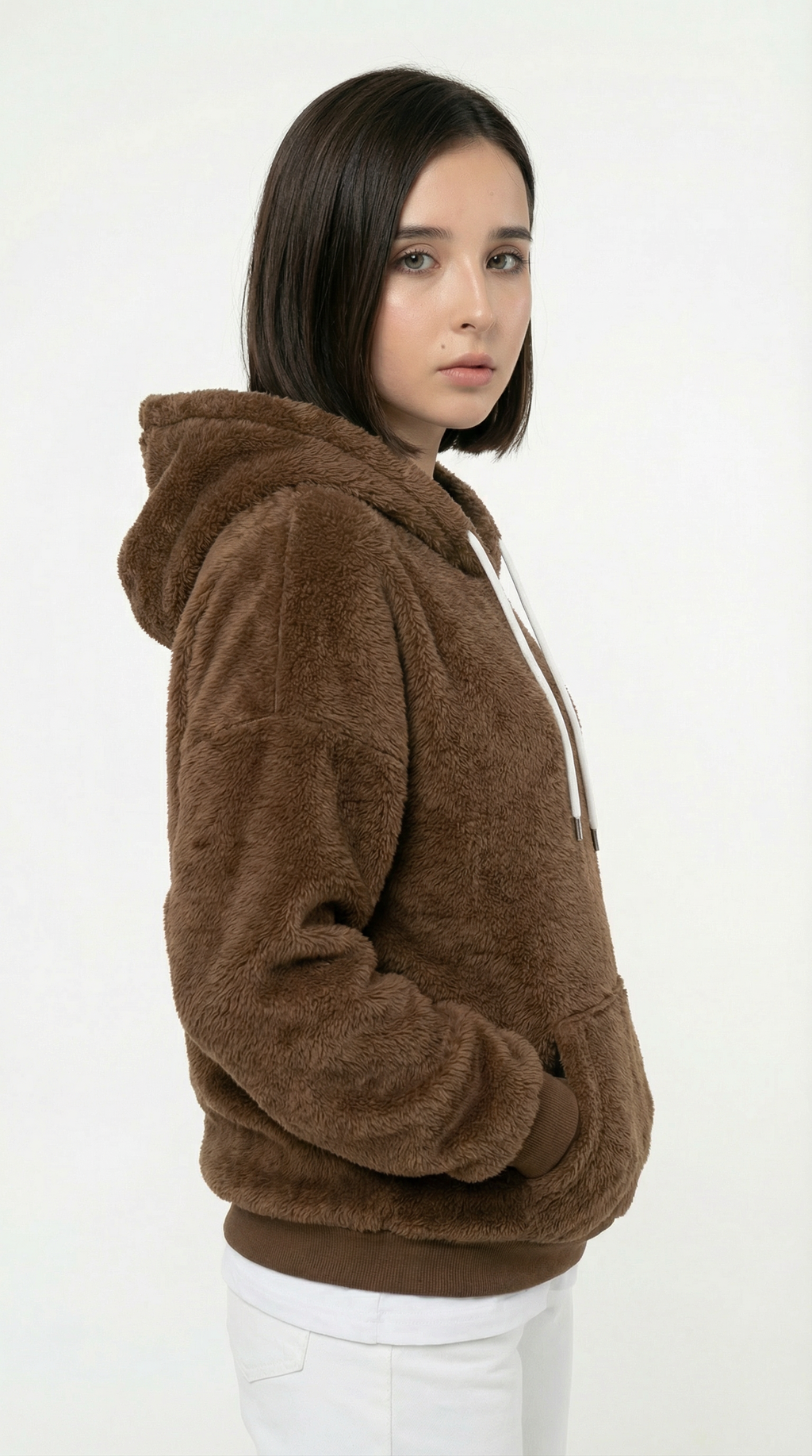 Woman wearing a brown fleece hoodie on a white background