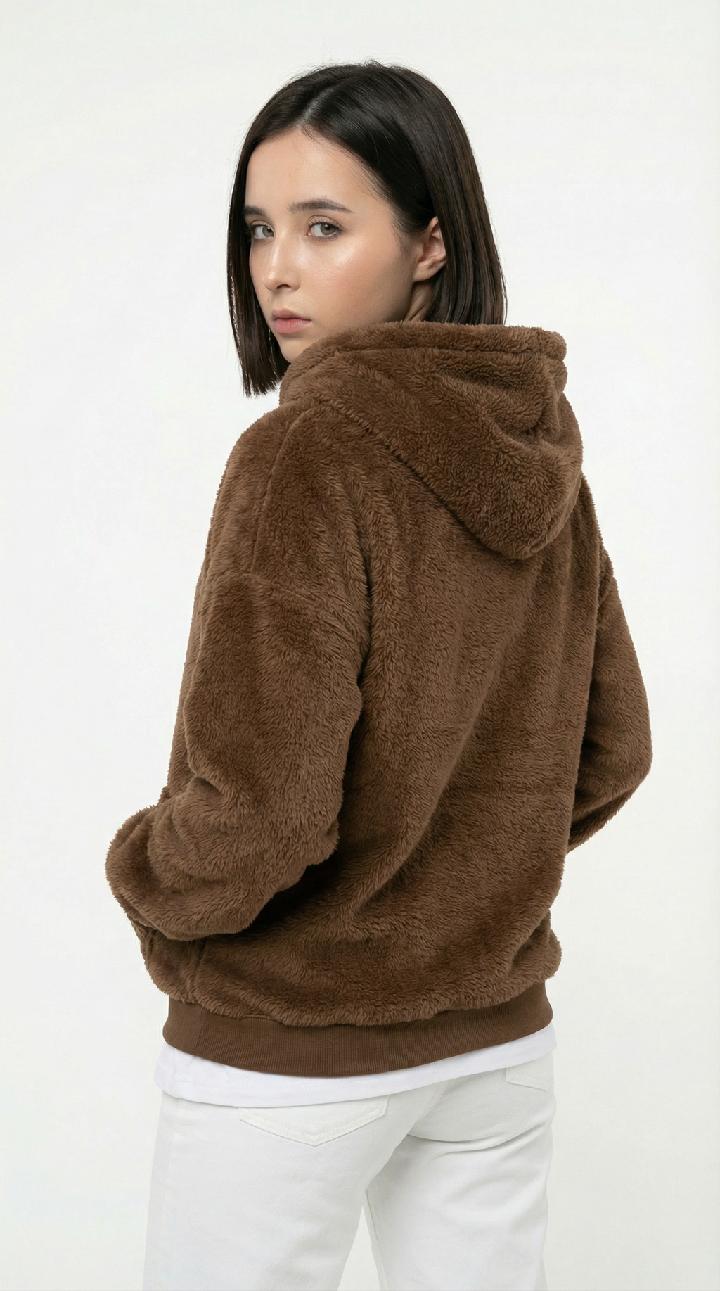 Woman wearing a brown fleece hoodie on a white background