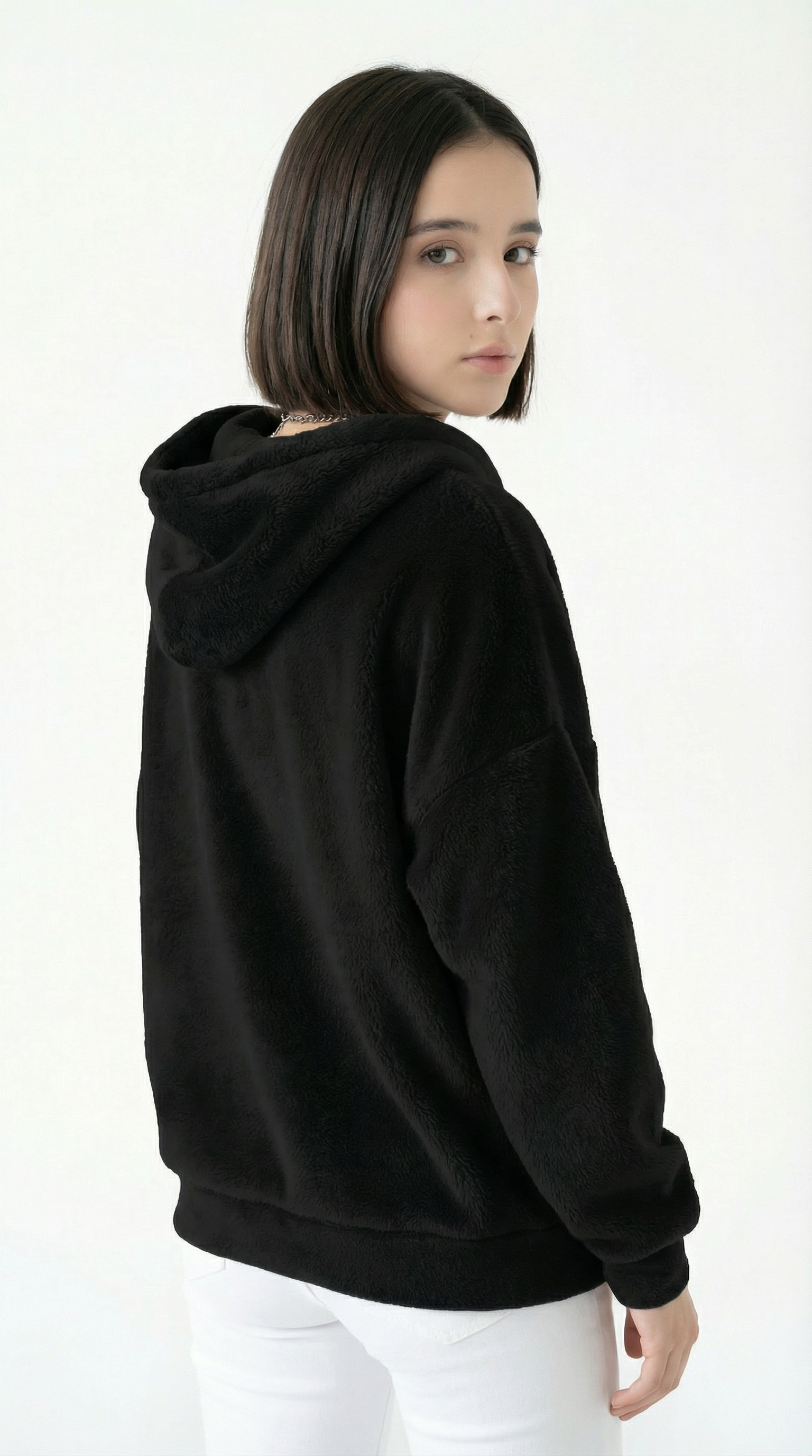 Person wearing a black hoodie on a white background
