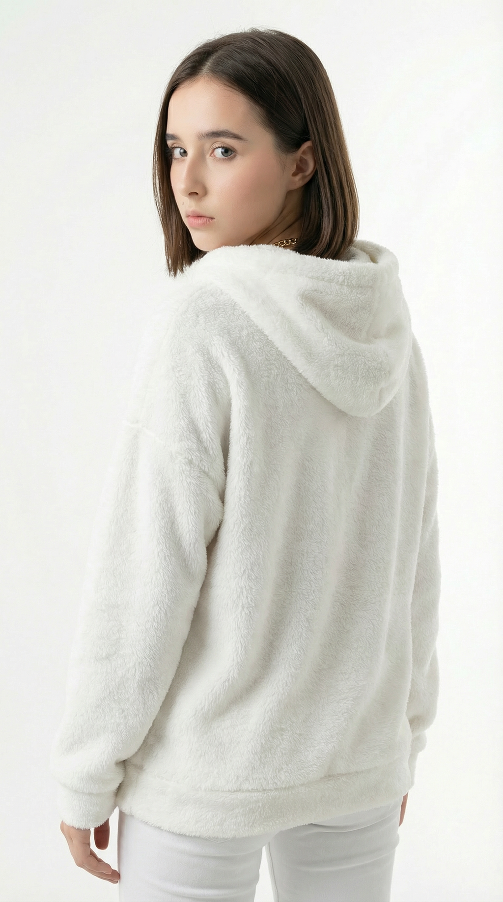 Woman wearing a white hoodie on a plain background