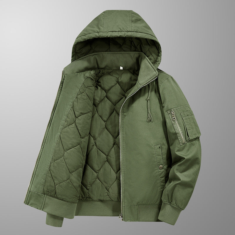 Green quilted jacket with a hood on a gray background