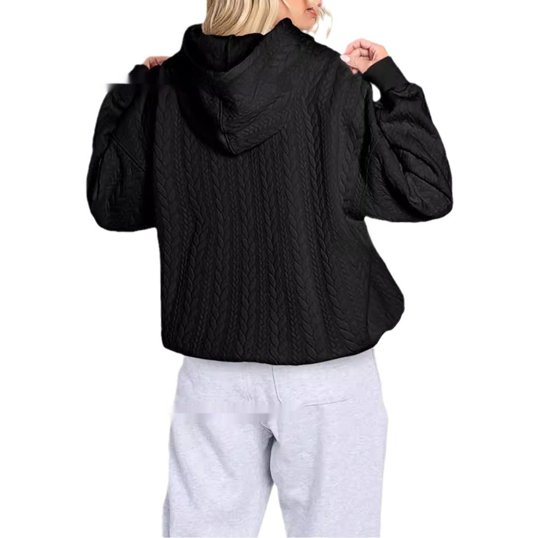 Person wearing a black quilted jacket on a white background
