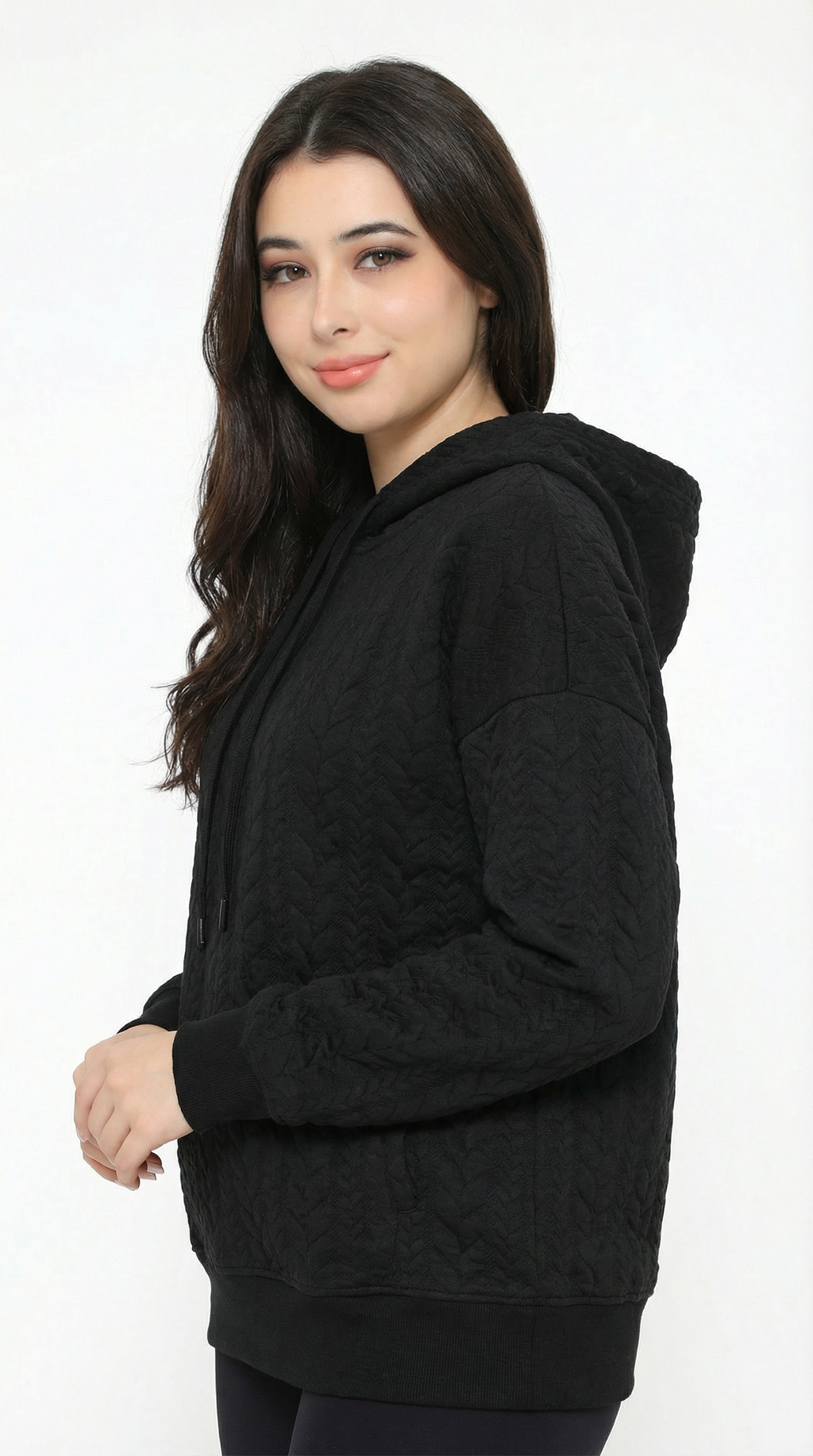 Woman wearing a black hoodie on a white background