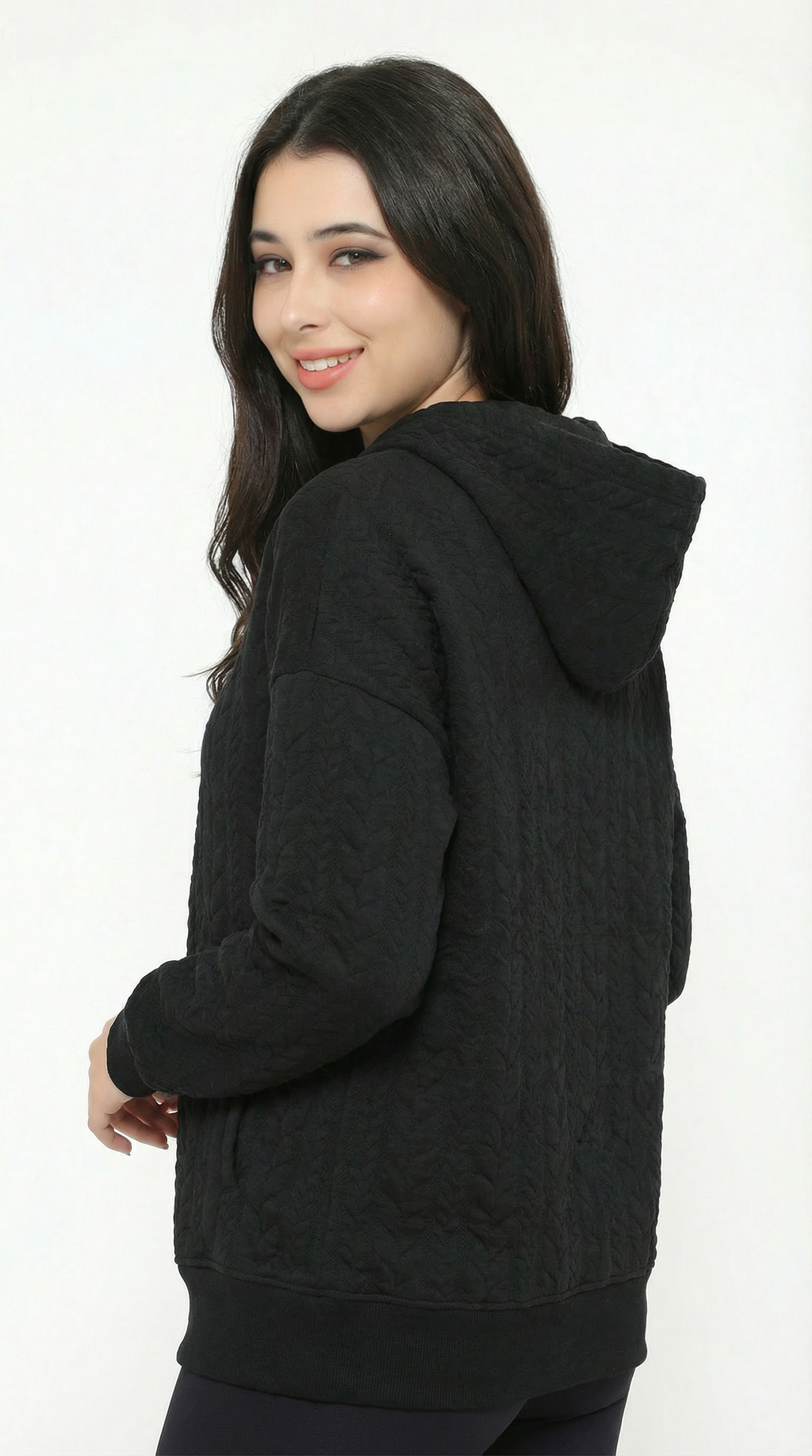 Woman wearing a black hoodie on a white background