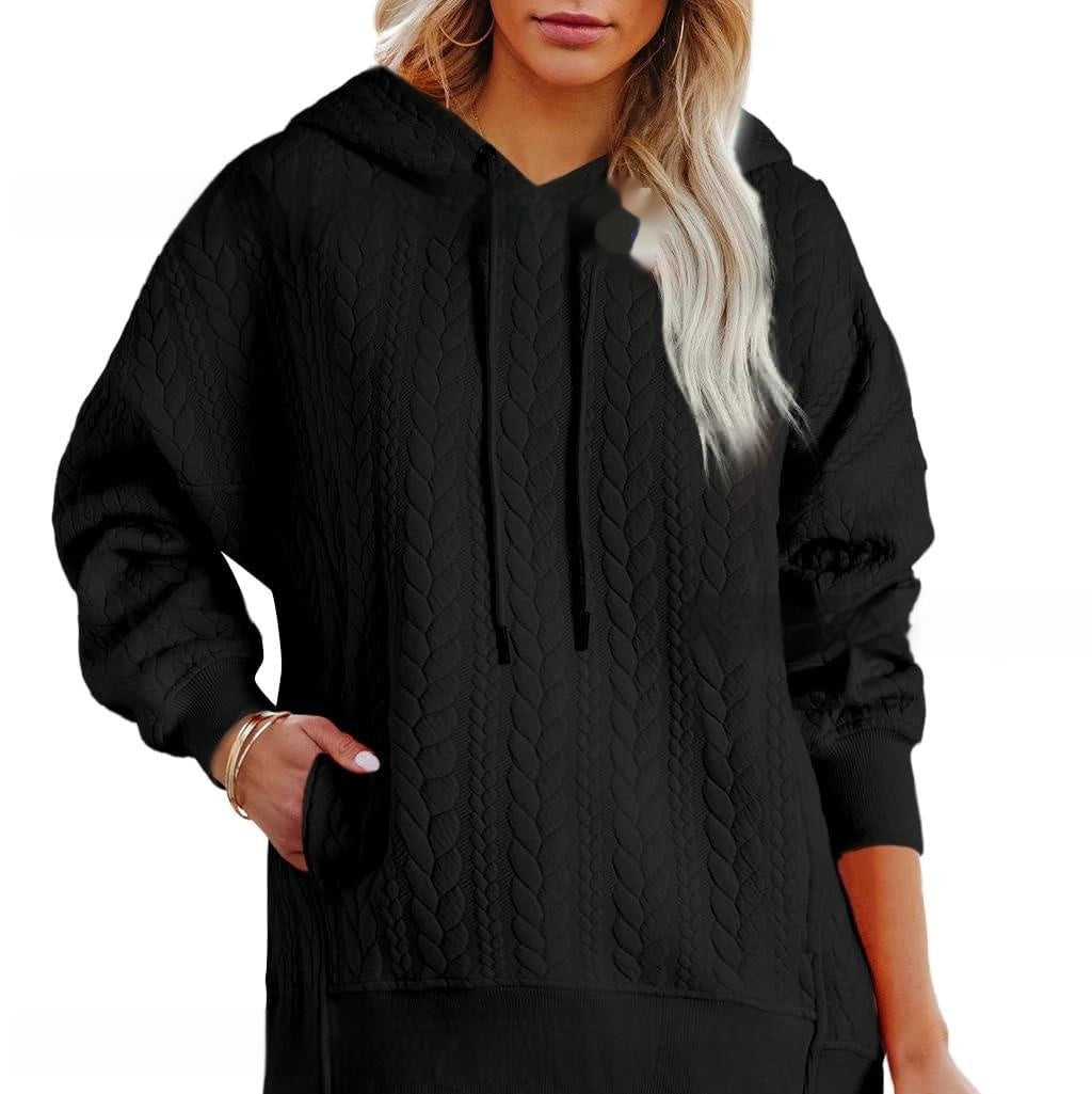 Black quilted jacket worn by a person on a white background