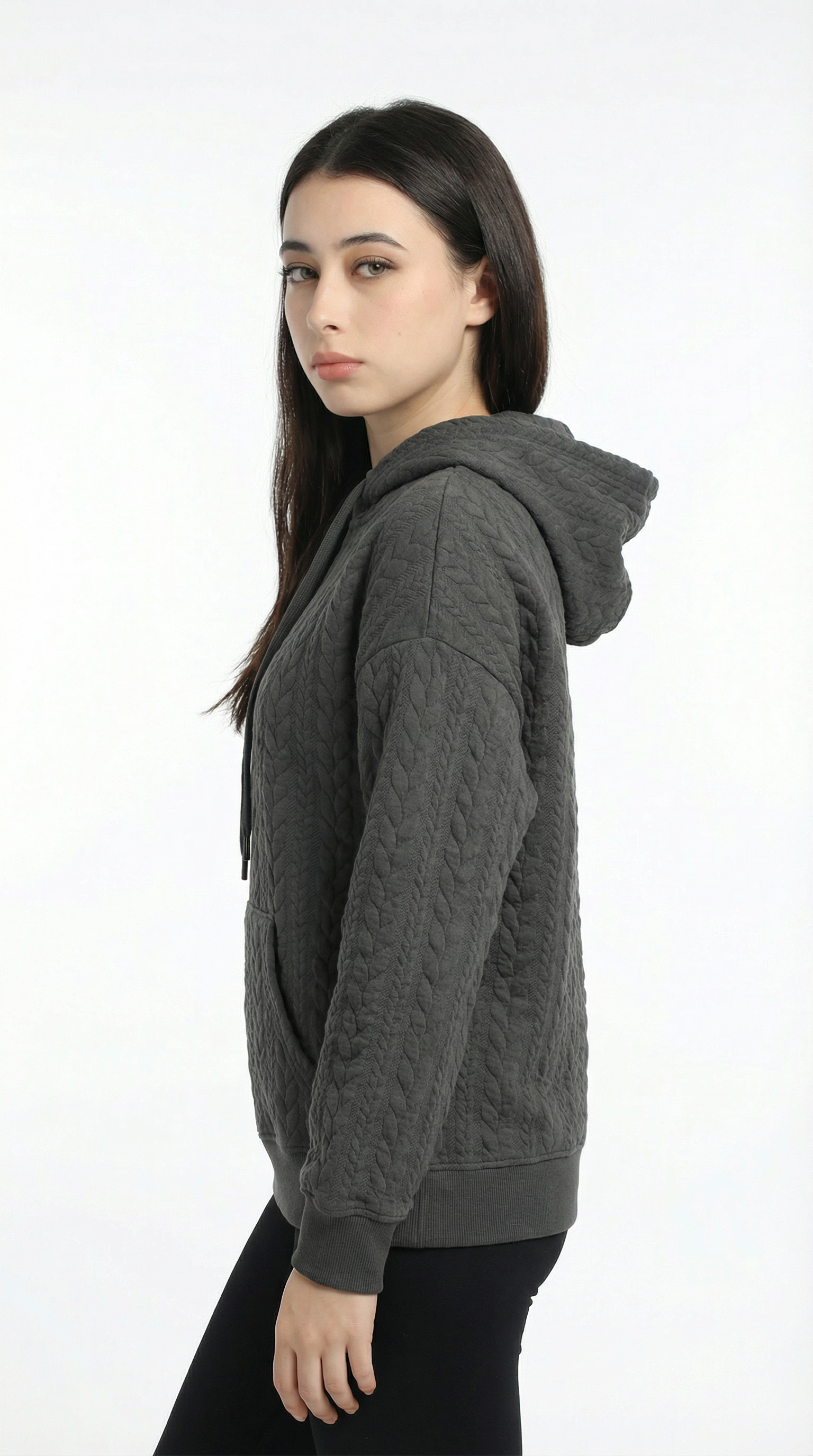 Woman wearing a gray hoodie on a white background