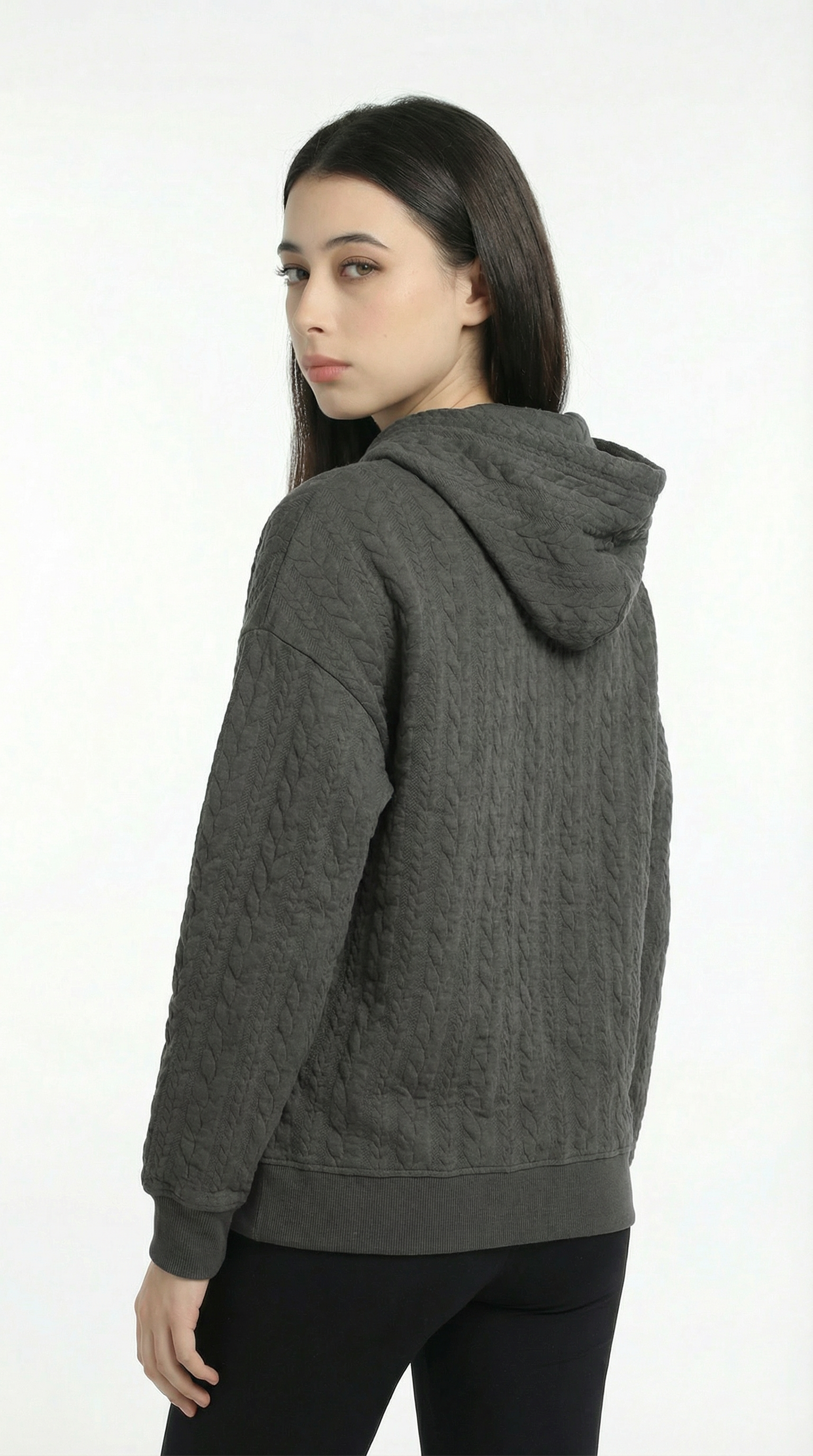 Woman wearing a gray hoodie on a white background