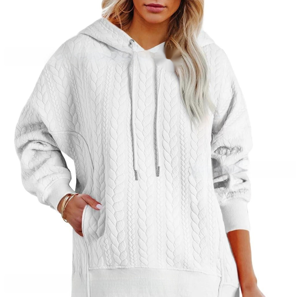 White cable knit hoodie worn by a person on a white background