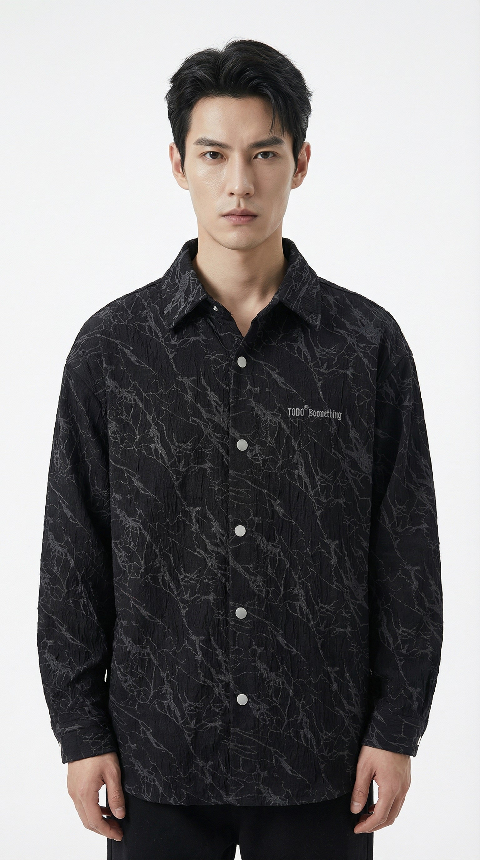 Two jackets, one green and one black, with visible branding on a textured surface.