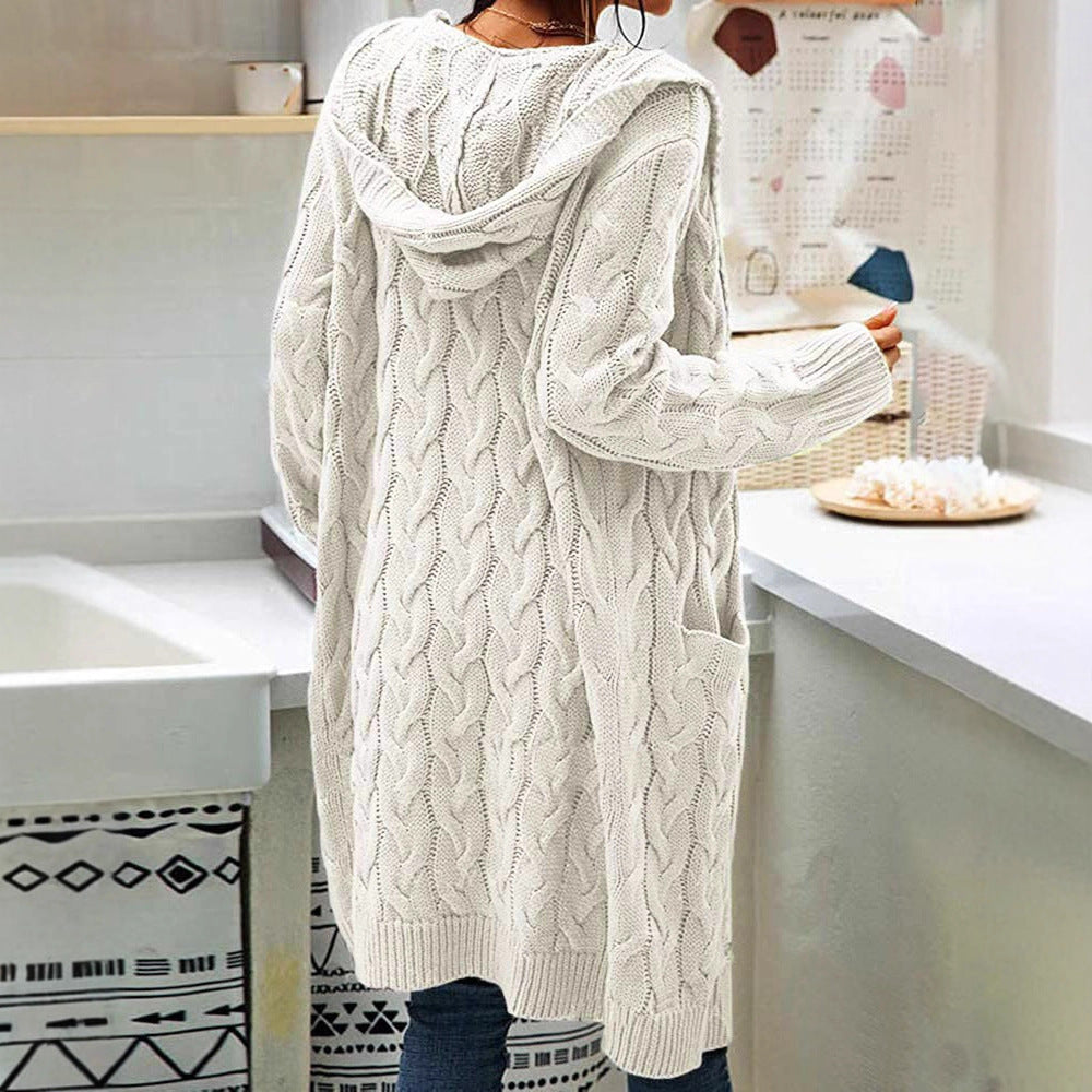 Person wearing a long cream cable knit cardigan from Meleche or Meléche (short as (Mé))