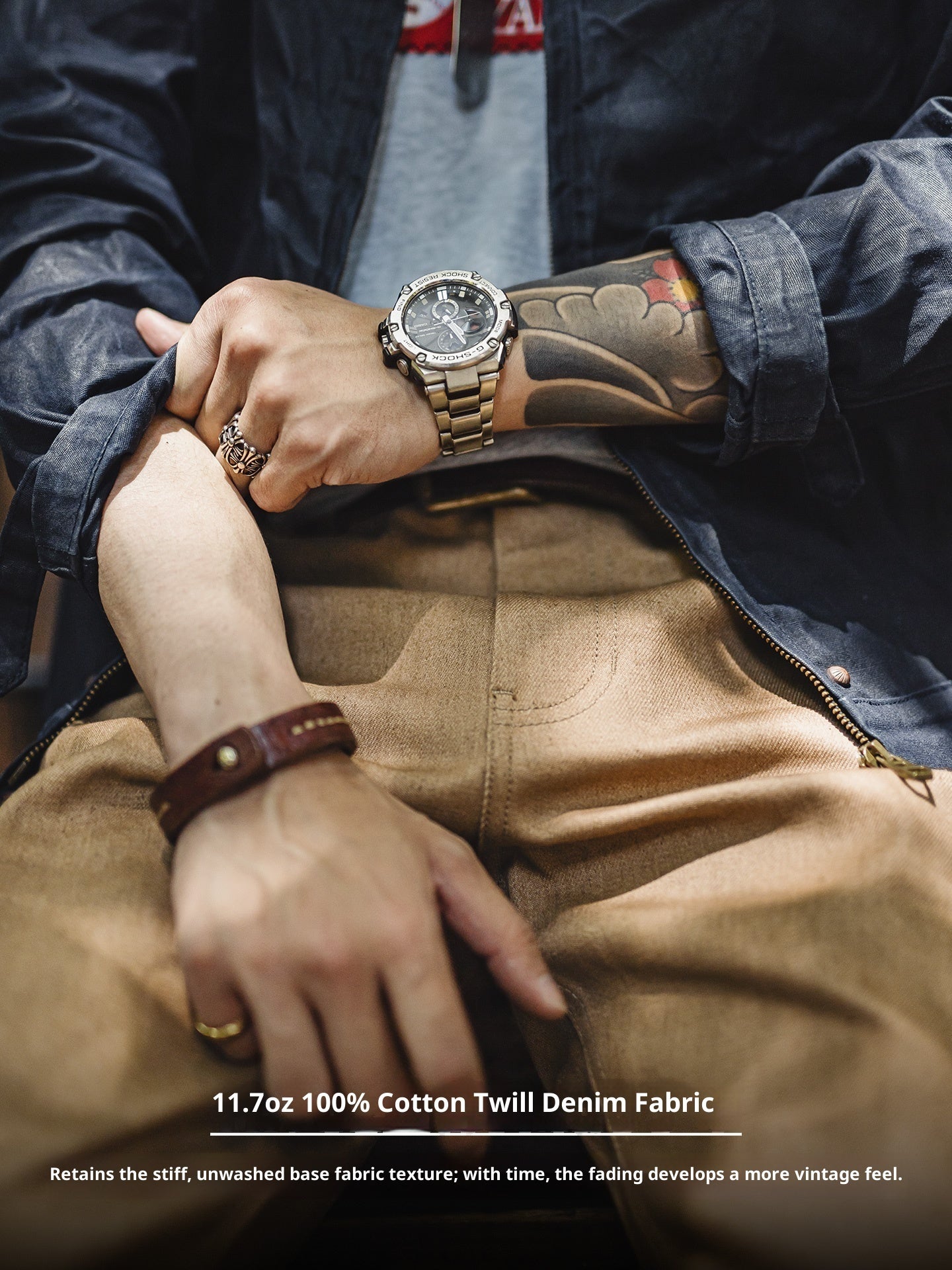 Close-up of hands wearing a watch and brown leather bracelet, with text about denim fabric.