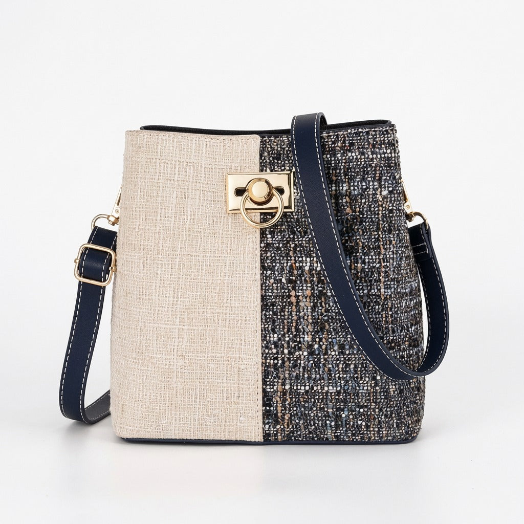 Two-tone handbag with beige and textured navy design on a white background