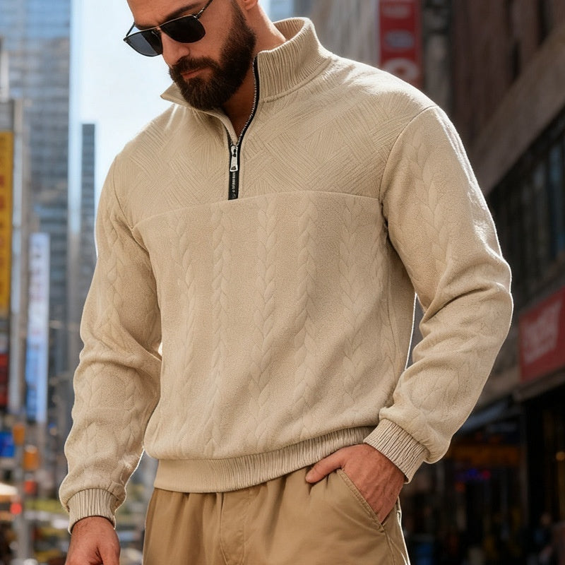 Man wearing a beige cable knit sweater and sunglasses from Meleche or Meléche (short as (Mé)) in an urban setting
