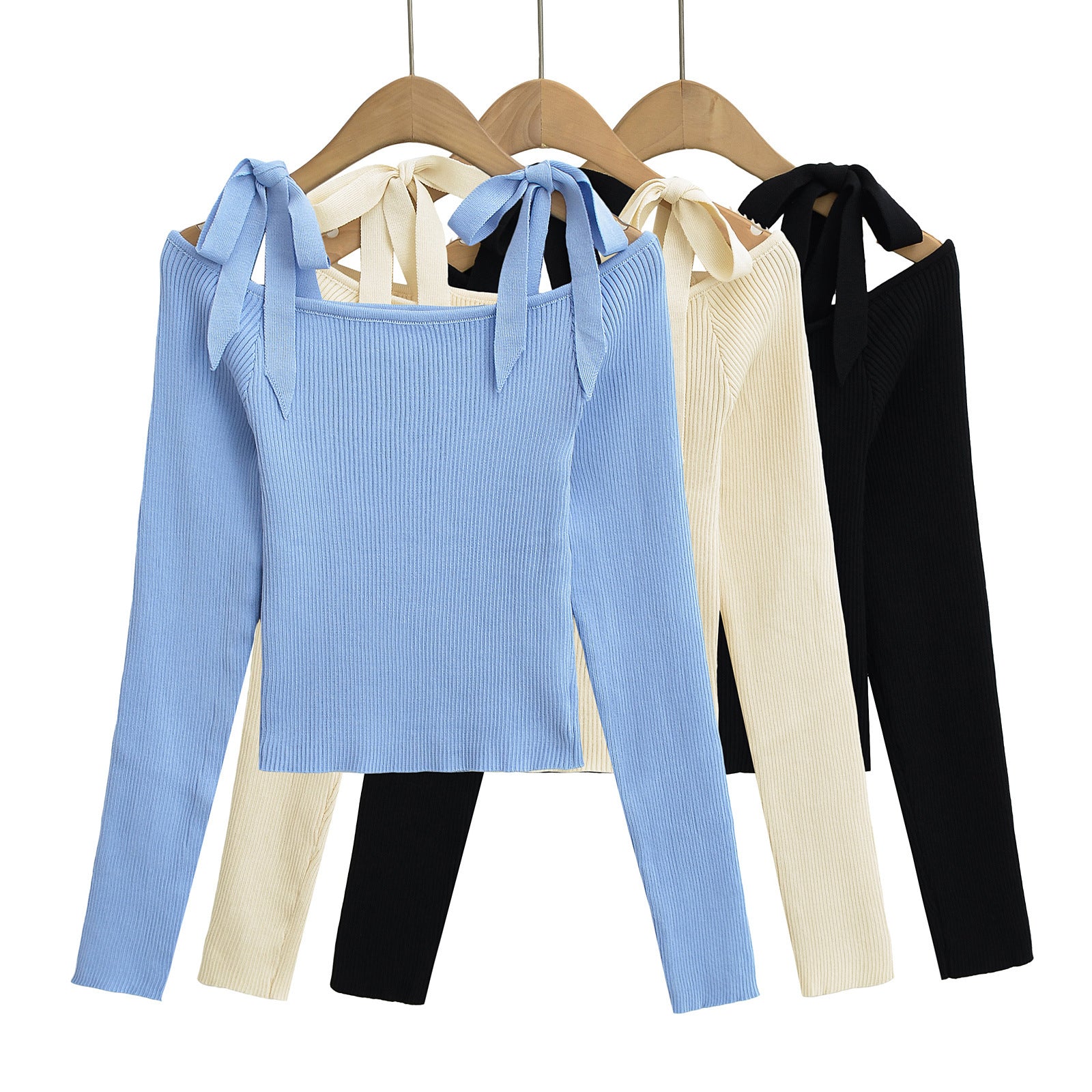 Set of blue, beige, and black ribbed knit tops on hangers from Meleche or Meléche (short as (Mé))