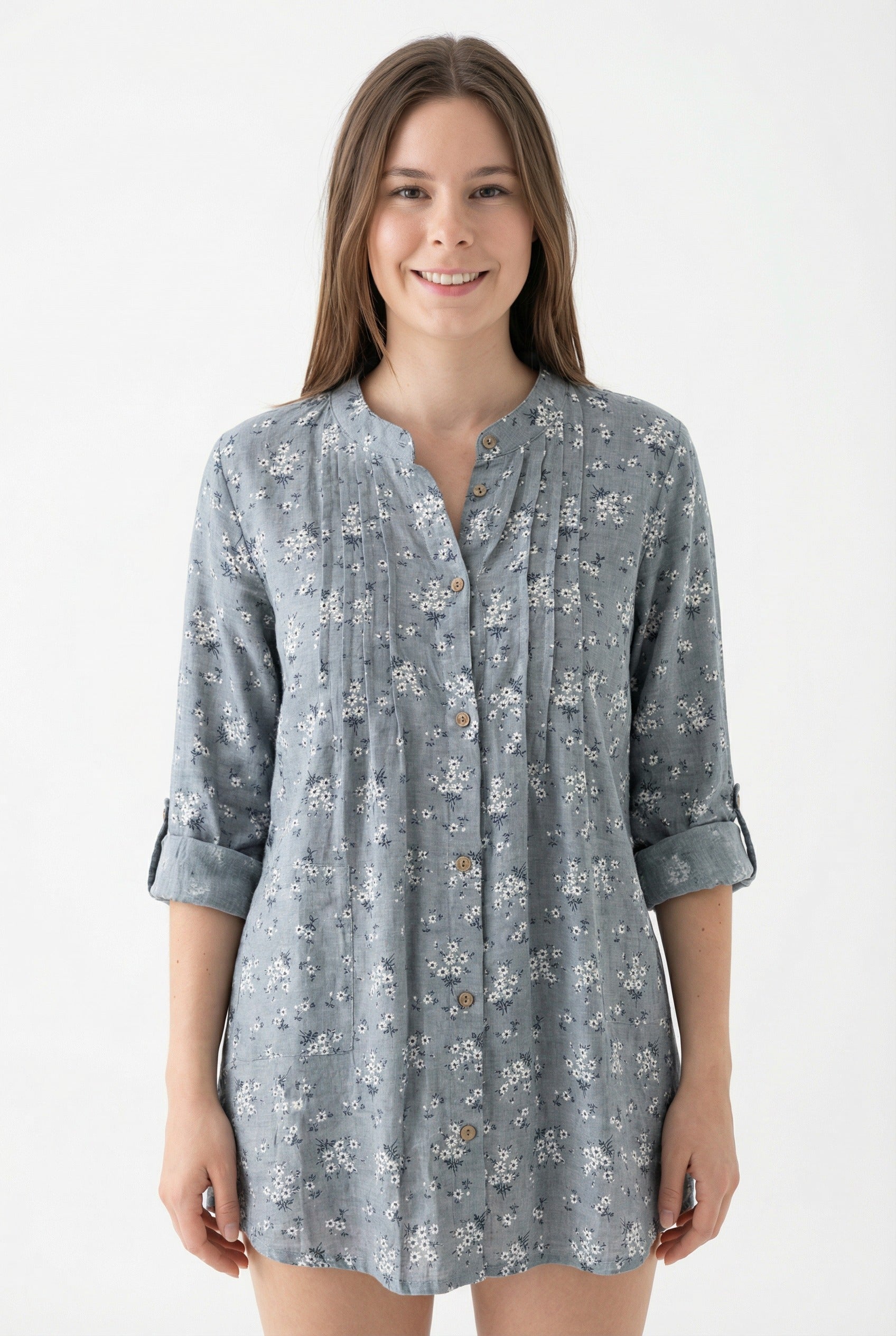 Woman wearing a gray floral patterned shirt on a white from Meleche or Meléche (short as (Mé))background