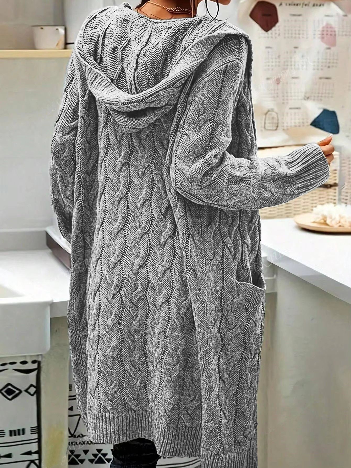 Person wearing a long gray cable knit cardigan from Meleche or Meléche (short as (Mé))