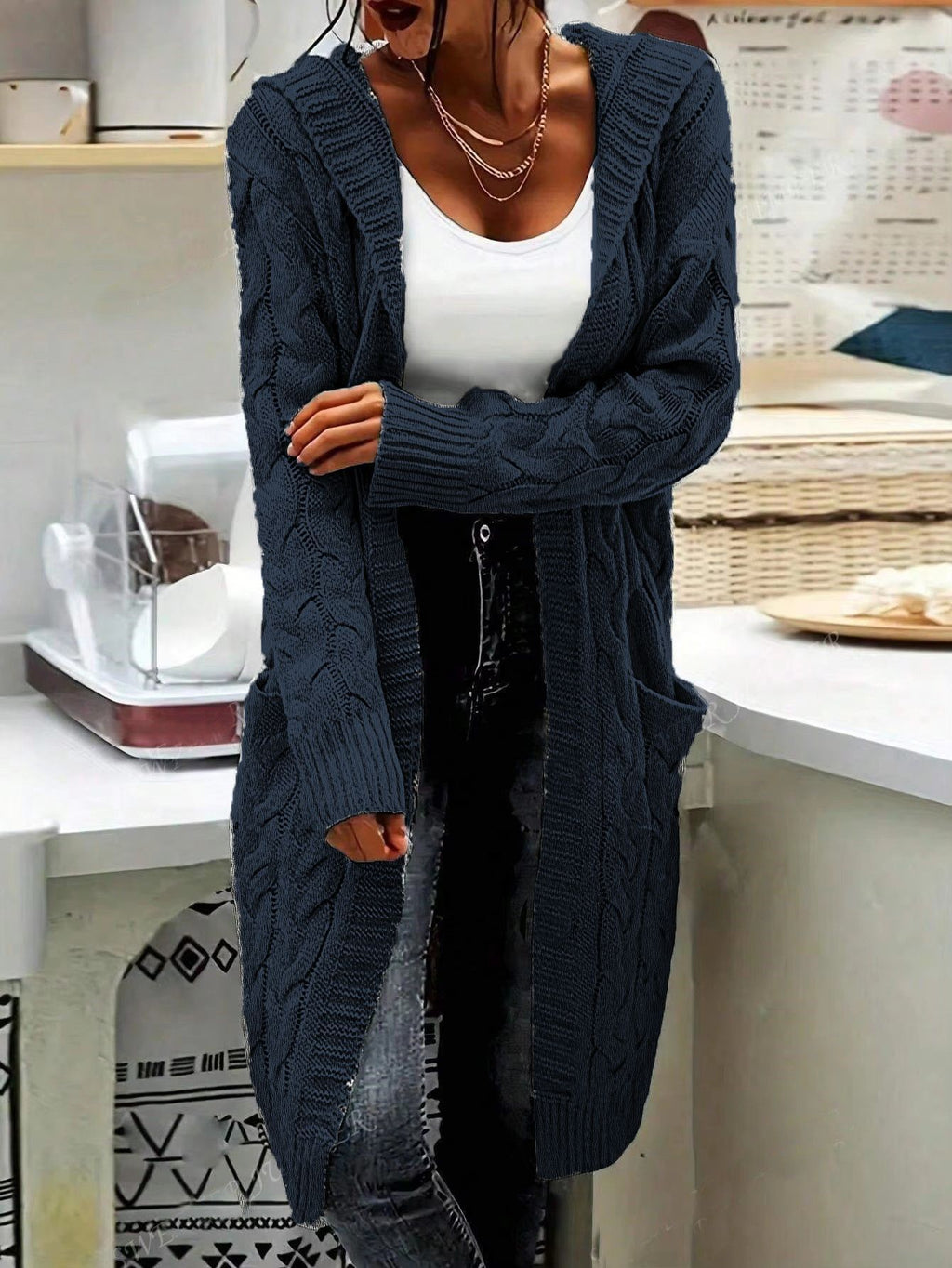 Person wearing a long navy blue cardigan from Meleche or Meléche (short as (Mé))