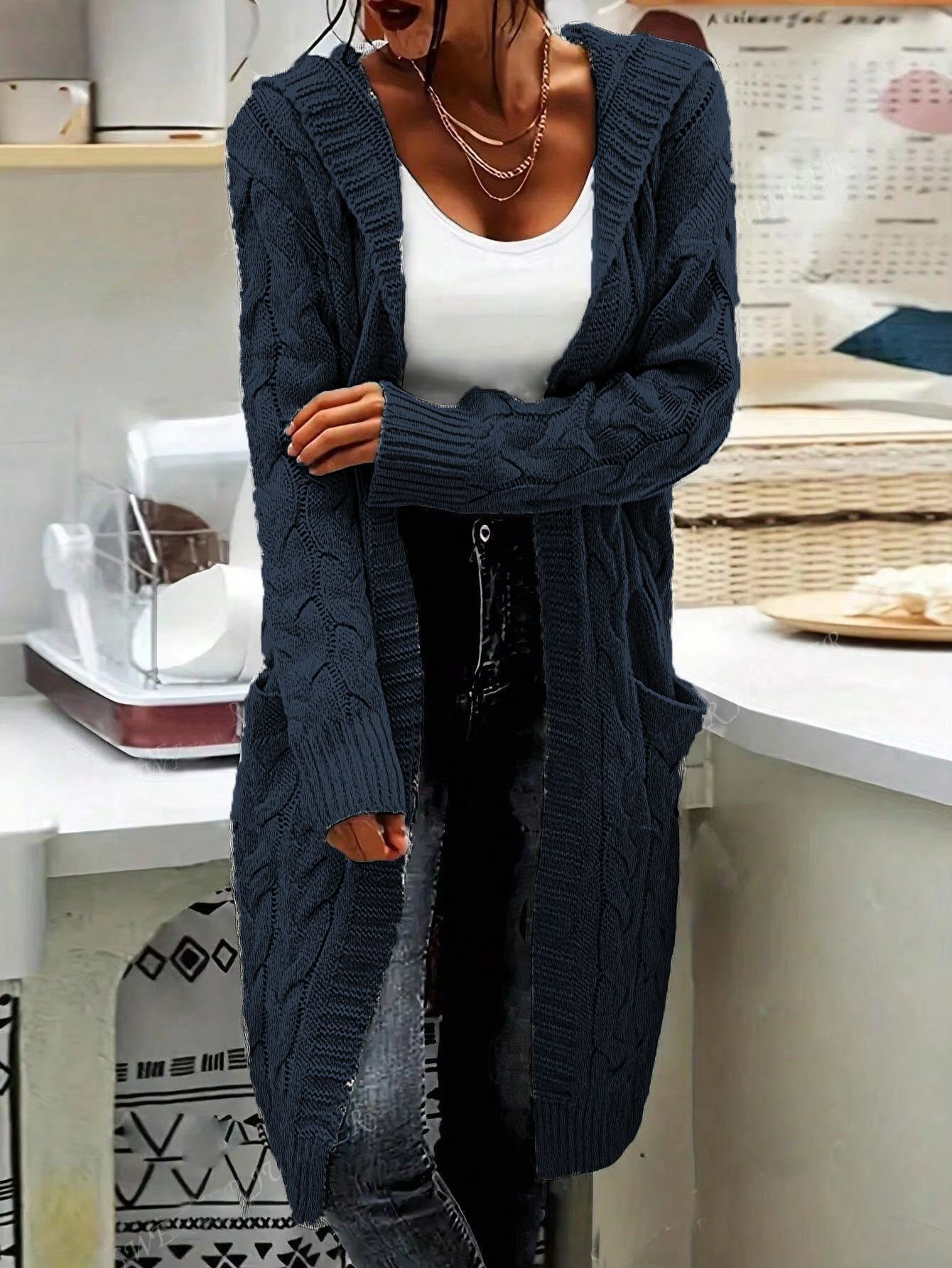 Person wearing a long navy blue cardigan from Meleche or Meléche (short as (Mé))