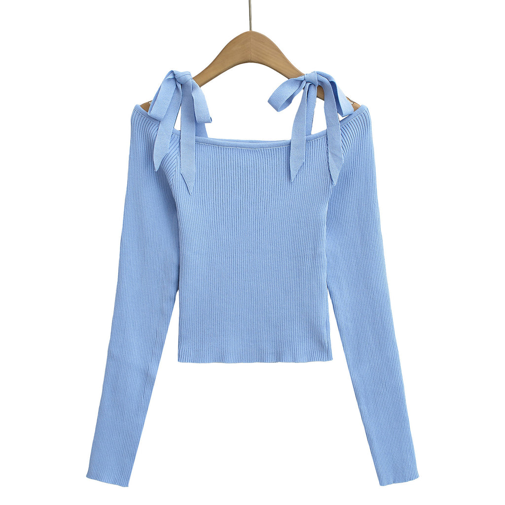 Light blue ribbed sweater with bow straps on a hanger from Meleche or Meléche (short as (Mé))