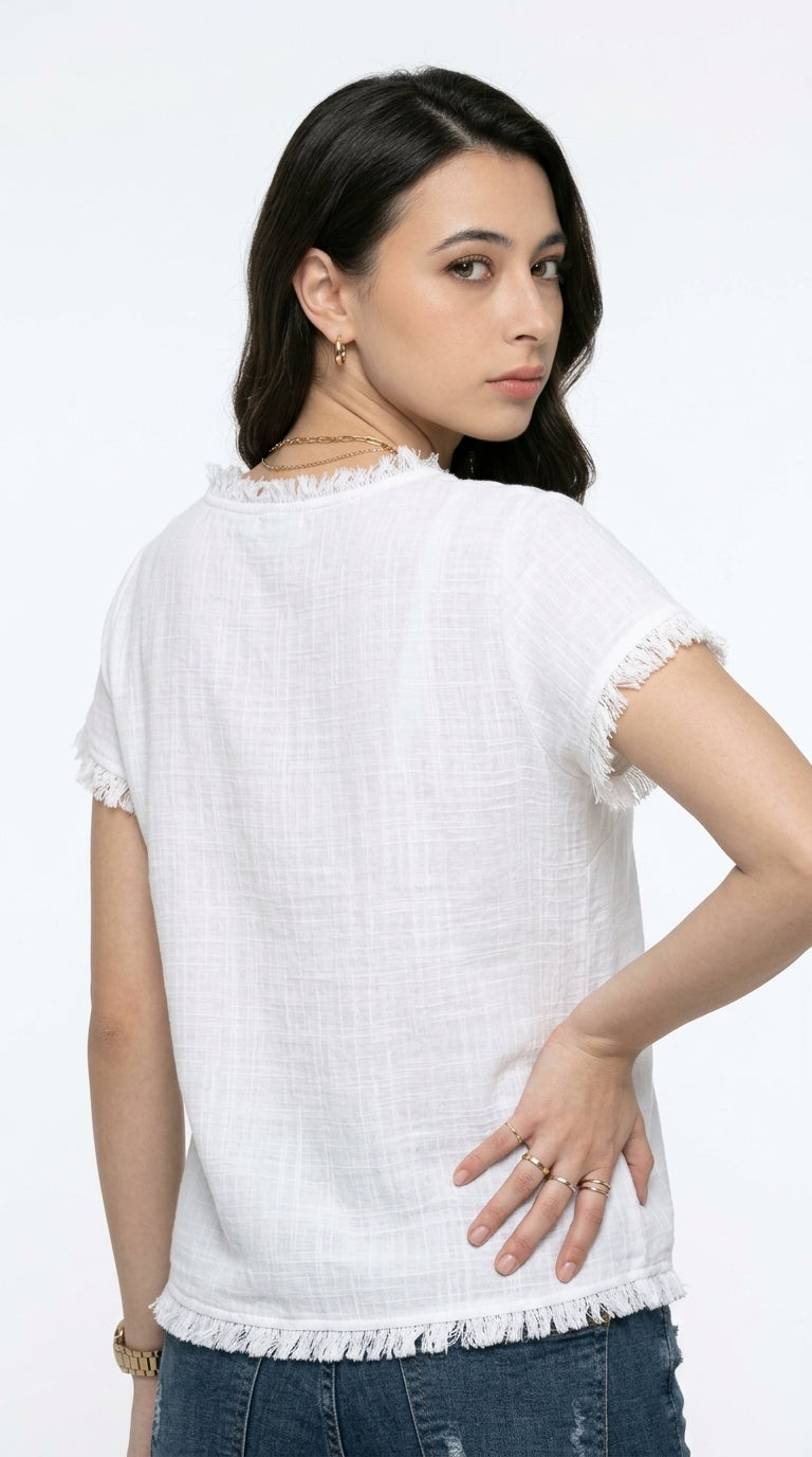A woman wearing a white short-sleeve top with frayed trim, shown from the back against a plain white background, from Meleche Fashion USA or Meléche (short as (Mé))